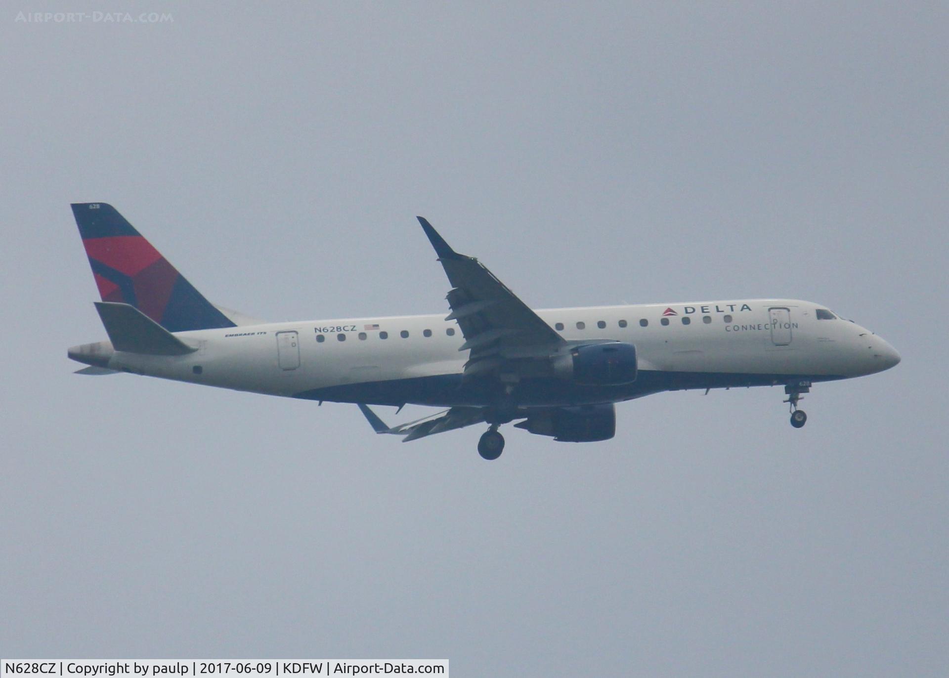 N628CZ, 2008 Embraer 175LR (ERJ-170-200LR) C/N 17000233, At DFW. After a 45 minute hold because of severe storms, starting to land in heavy rain.
