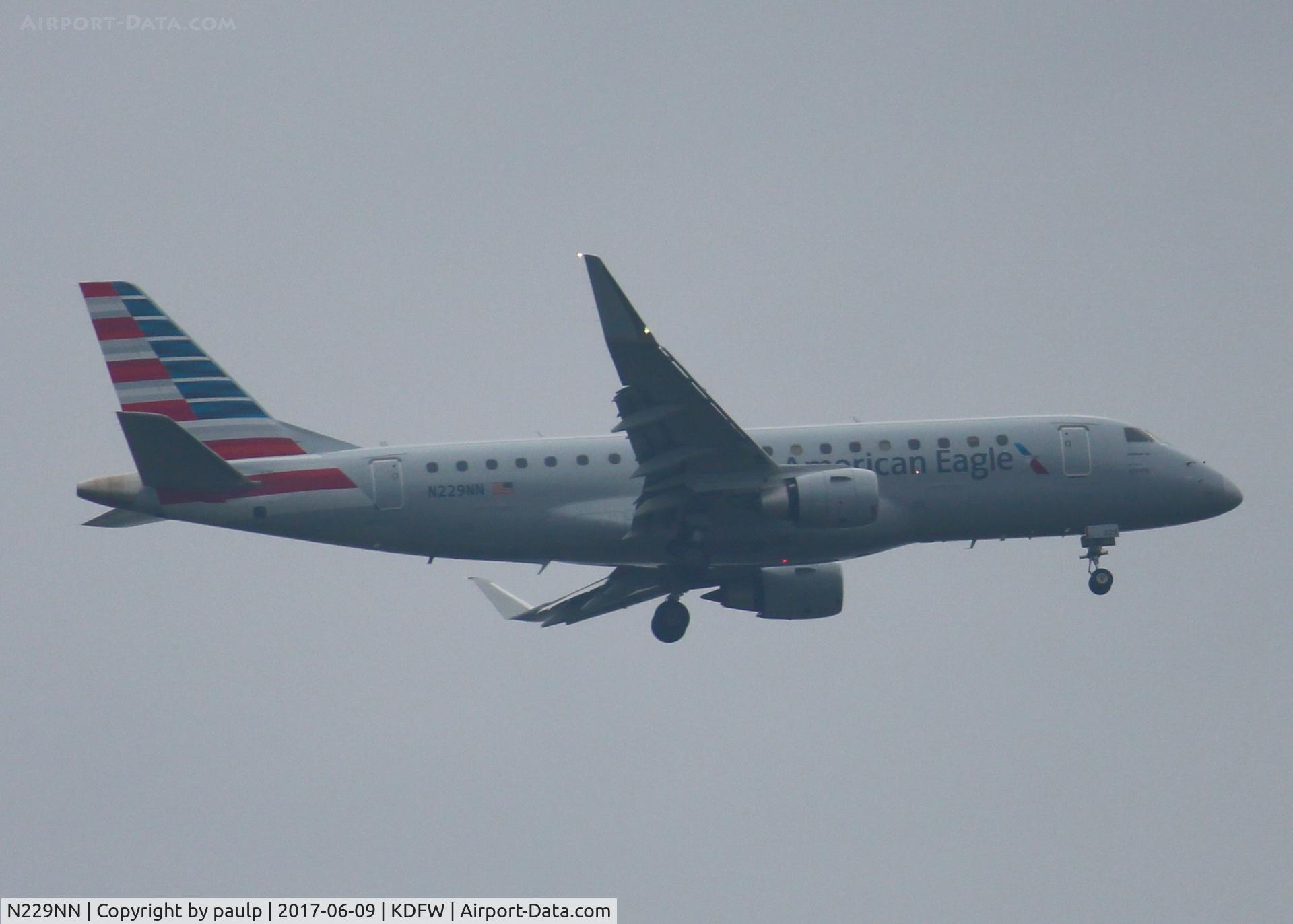 N229NN, 2016 Embraer 175LR (ERJ-170-200LR) C/N 17000547, At DFW. After a 45 minute hold because of severe storms, starting to land in heavy rain.