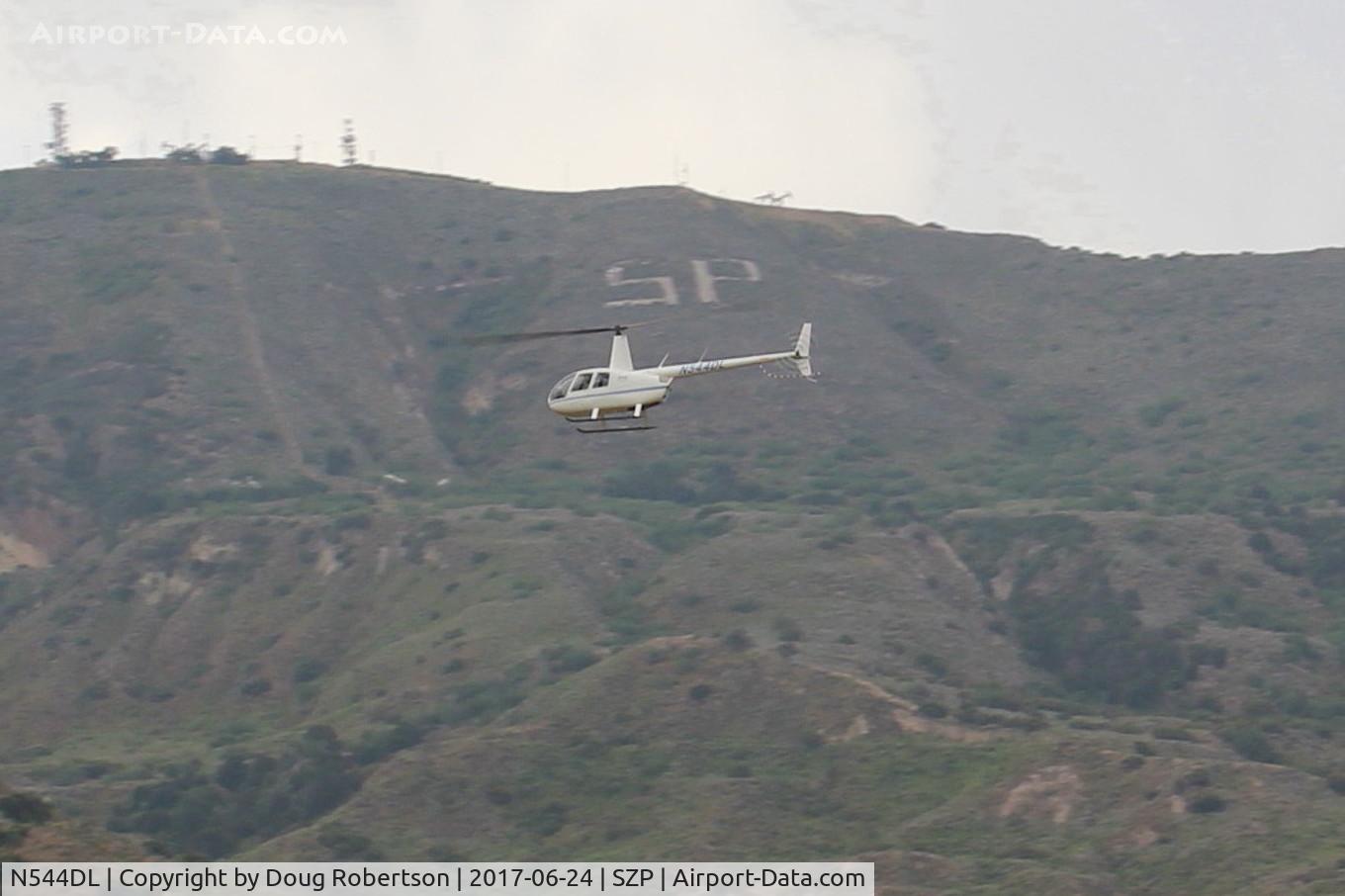 N544DL, 2005 Robinson R44 Raven II C/N 10783, 2005 Robinson R44 RAVEN II, Lycoming IO-540-AE1A5 6 cylinder 260 Hp derated to 225 Hp for takeoff, 205 Hp continuous. Departure from near it's SZP hangar area.