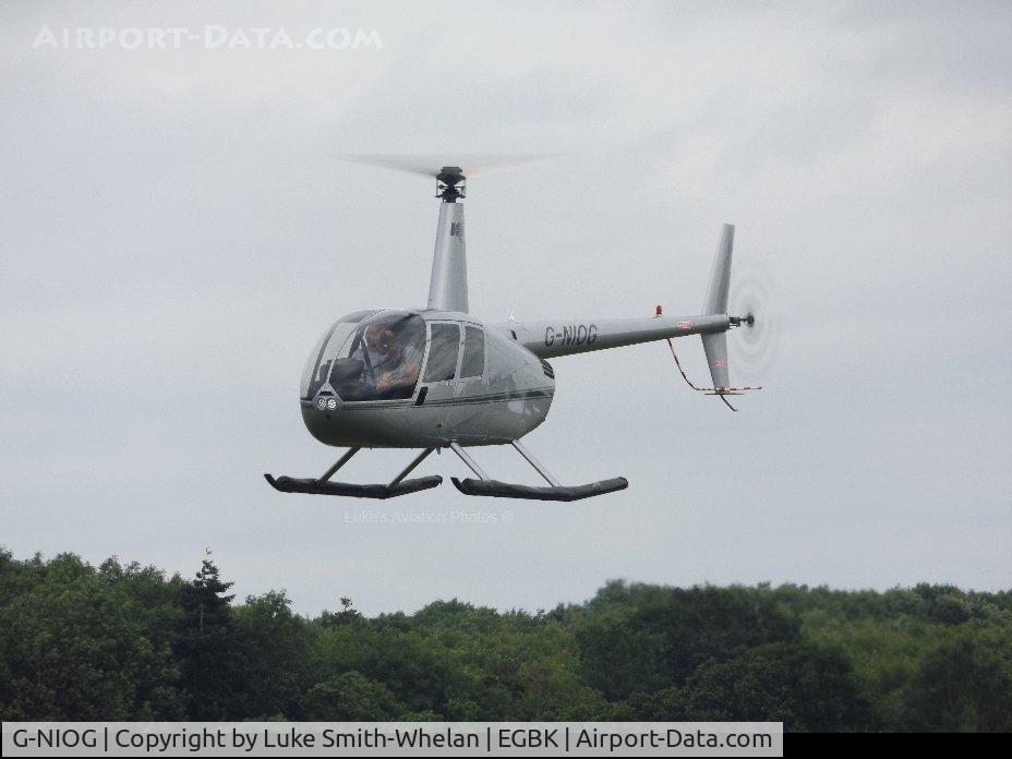 G-NIOG, 2004 Robinson R44 Clipper II C/N 10471, Departing Sywell Aerodrome.