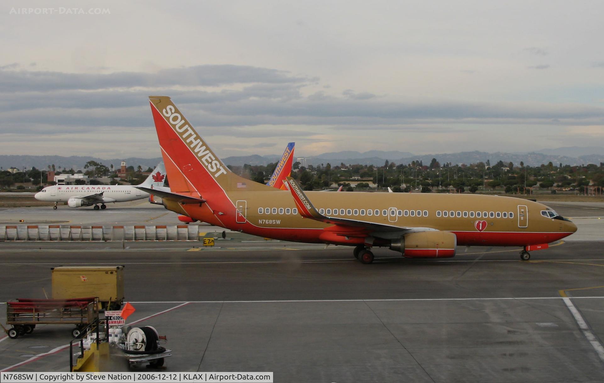 N768SW, 2000 Boeing 737-7H4 C/N 30587, SOUTHWEST 2000 Boeing 737-7H4 with winglets and in old colors taxiing for take-off @ LAX in late afternoon
