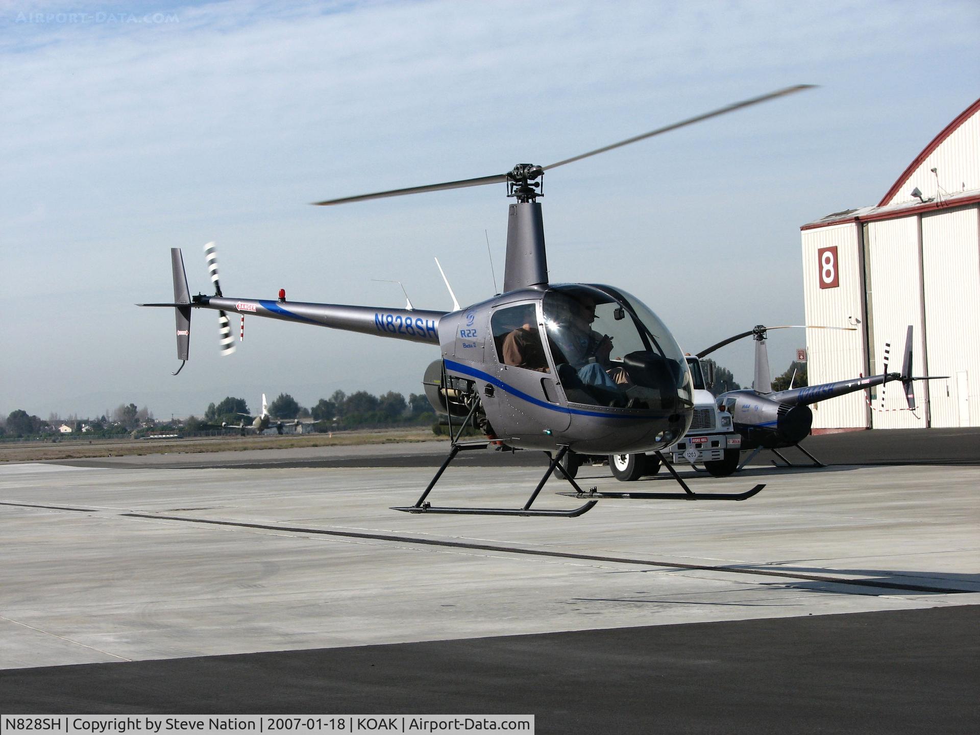 N828SH, 2005 Robinson R22 Beta C/N 3786, Silver State Helicopters 2005 Robinson R22 BETA in hover @ Oakland International Airport, CA North ramp (to Humbird Helicopters 2009-08-07)