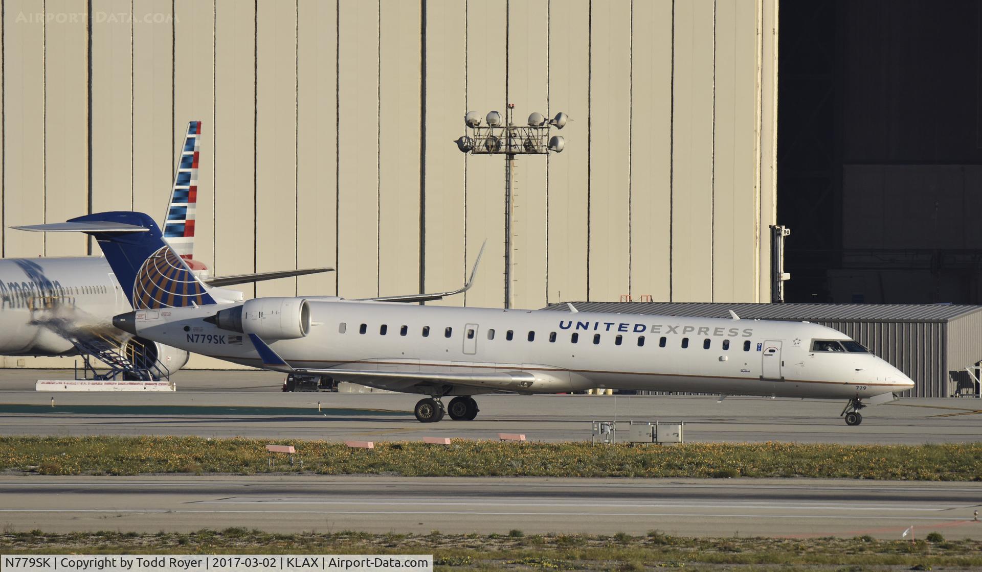 N779SK, 2009 Bombardier CRJ-702 (CL-600-2C10) Regional Jet C/N 10276, Taxiing to gate at LAX