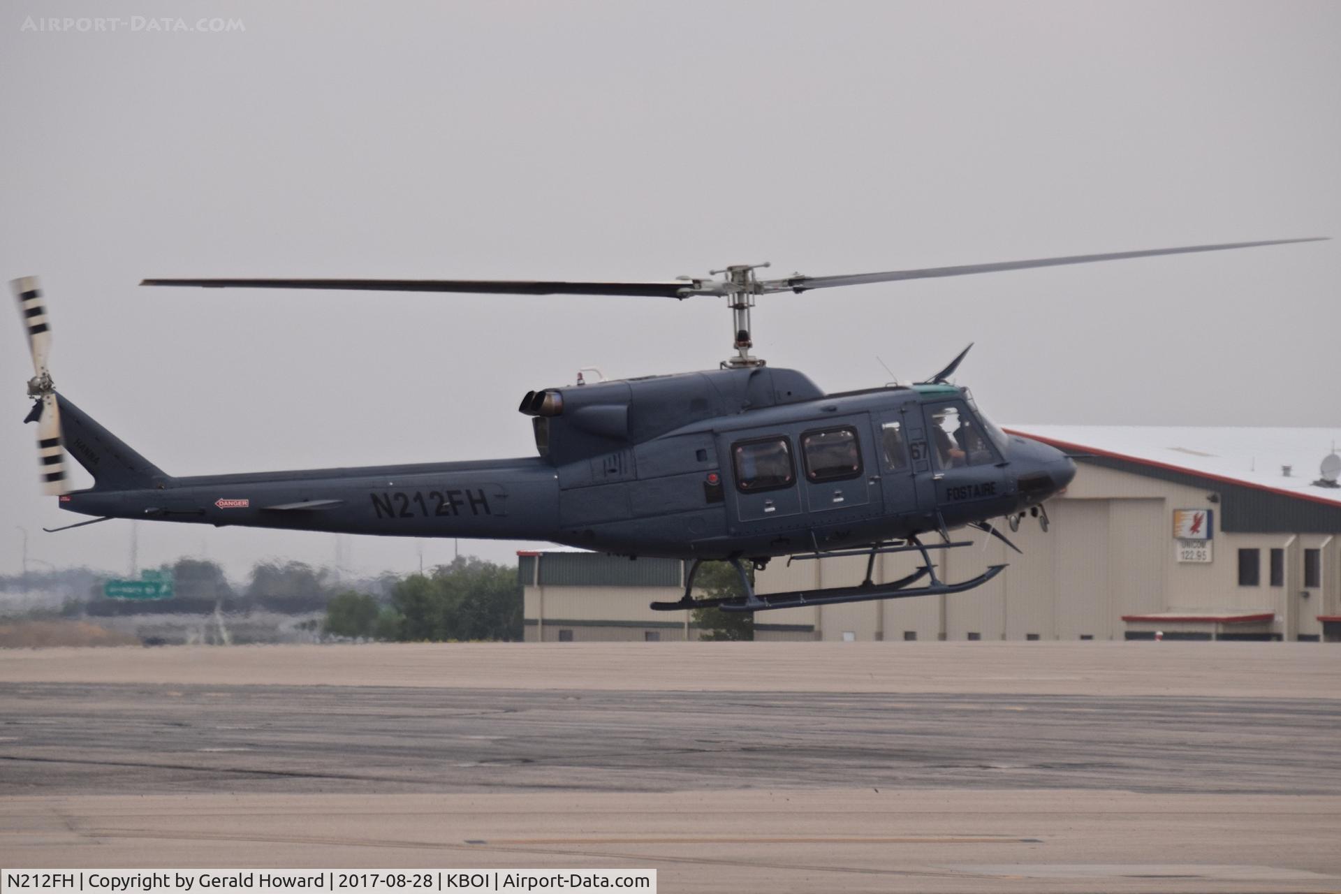 N212FH, Bell 212 C/N 3026, Landing on north GA ramp.