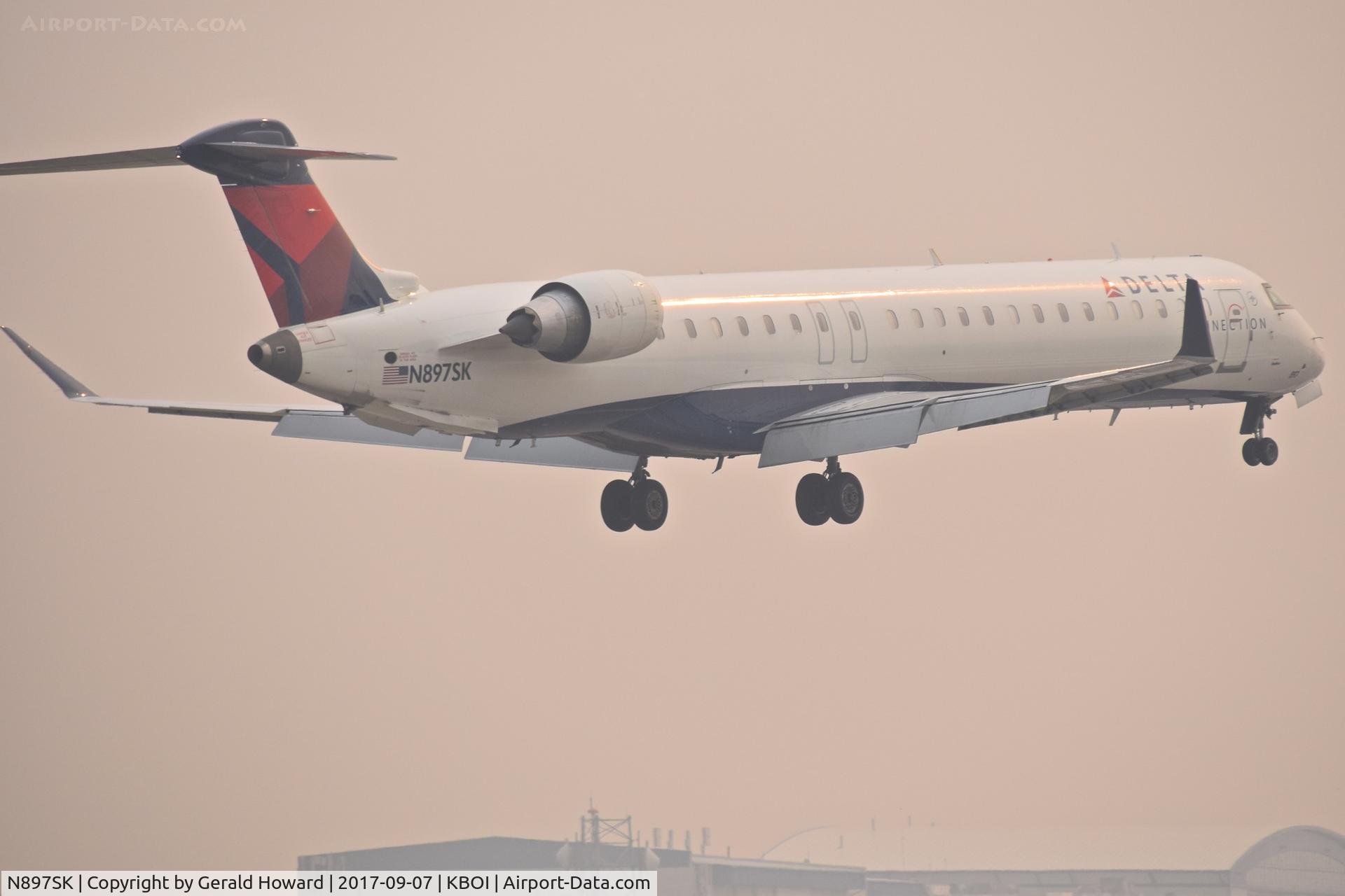 N897SK, 2006 Canadair CRJ-900LR (CL-600-2D24) C/N 15103, IFR landing on RWY 10R.  1 & 3/4 mile smoke.