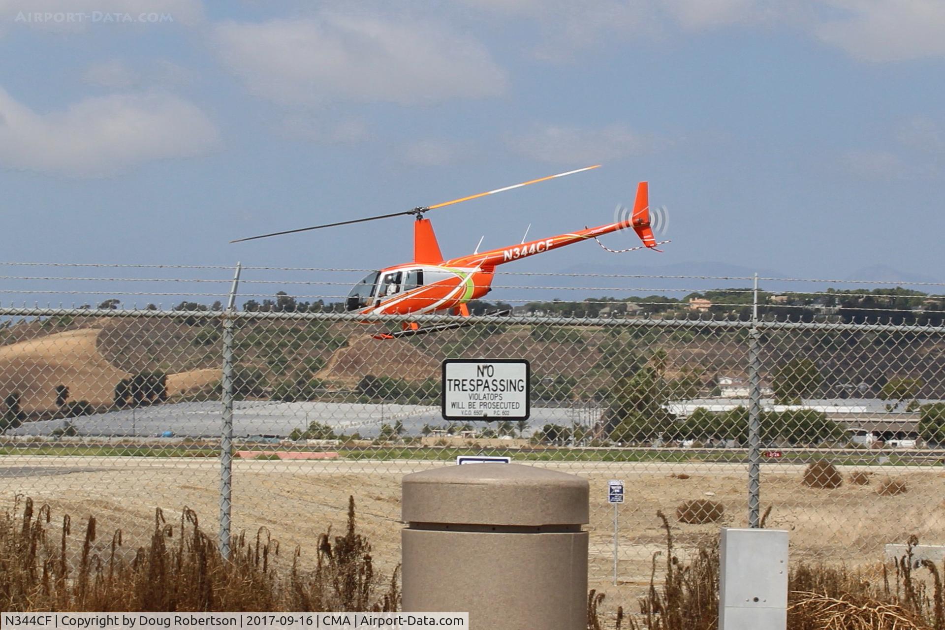 N344CF, 2004 Robinson R44 Raven II C/N 10440, 2004 Robinson R44 RAVEN II, one Lycoming IO-540-AE1A5 6 cylinder flat-rated to 245 BHp, at SUN AIR JETS ramp, liftoff departure