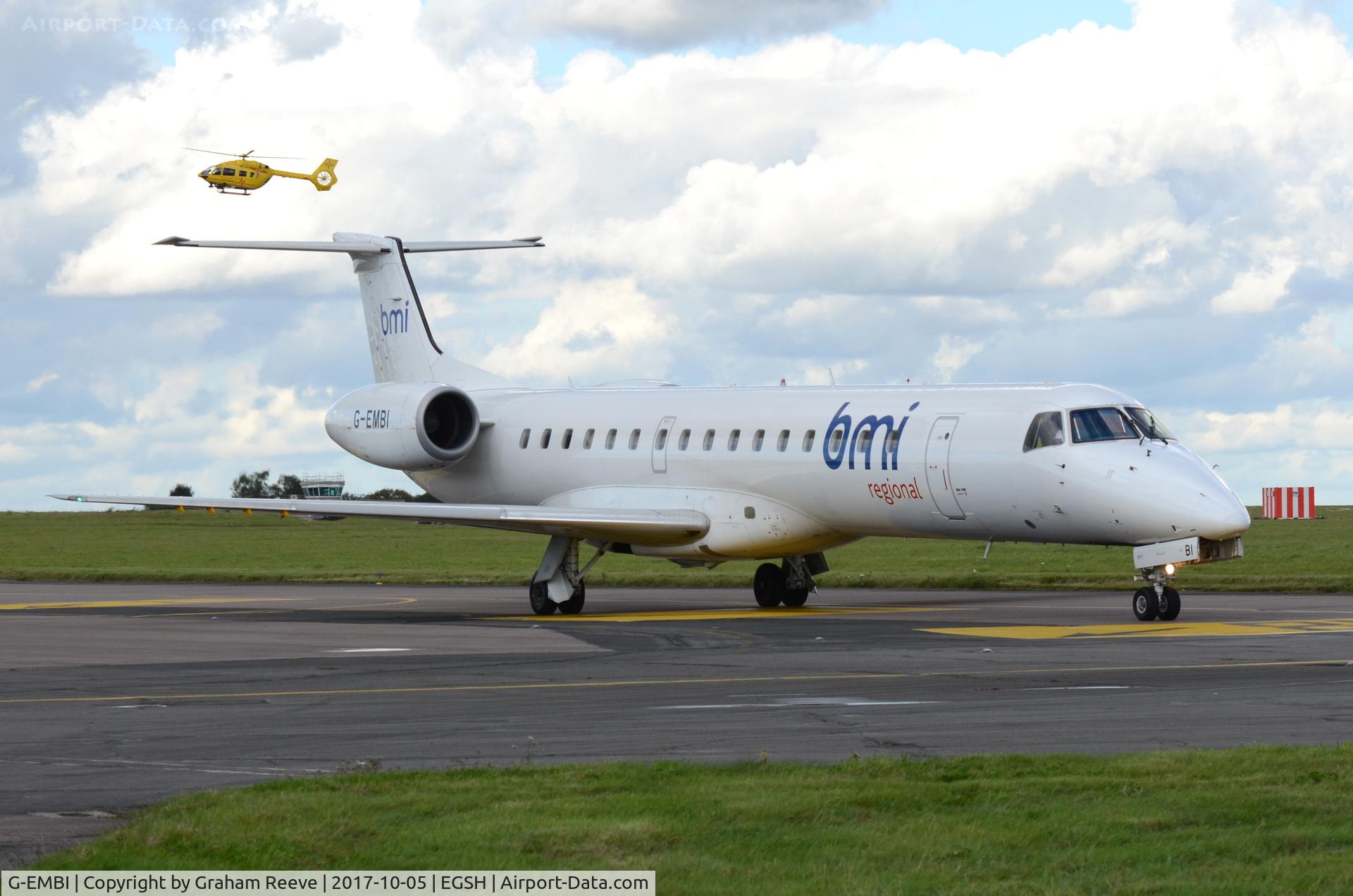 G-EMBI, 1999 Embraer EMB-145EU (ERJ-145EU) C/N 145126, Just landed at Norwich, with the Air Ambulance in the back ground.