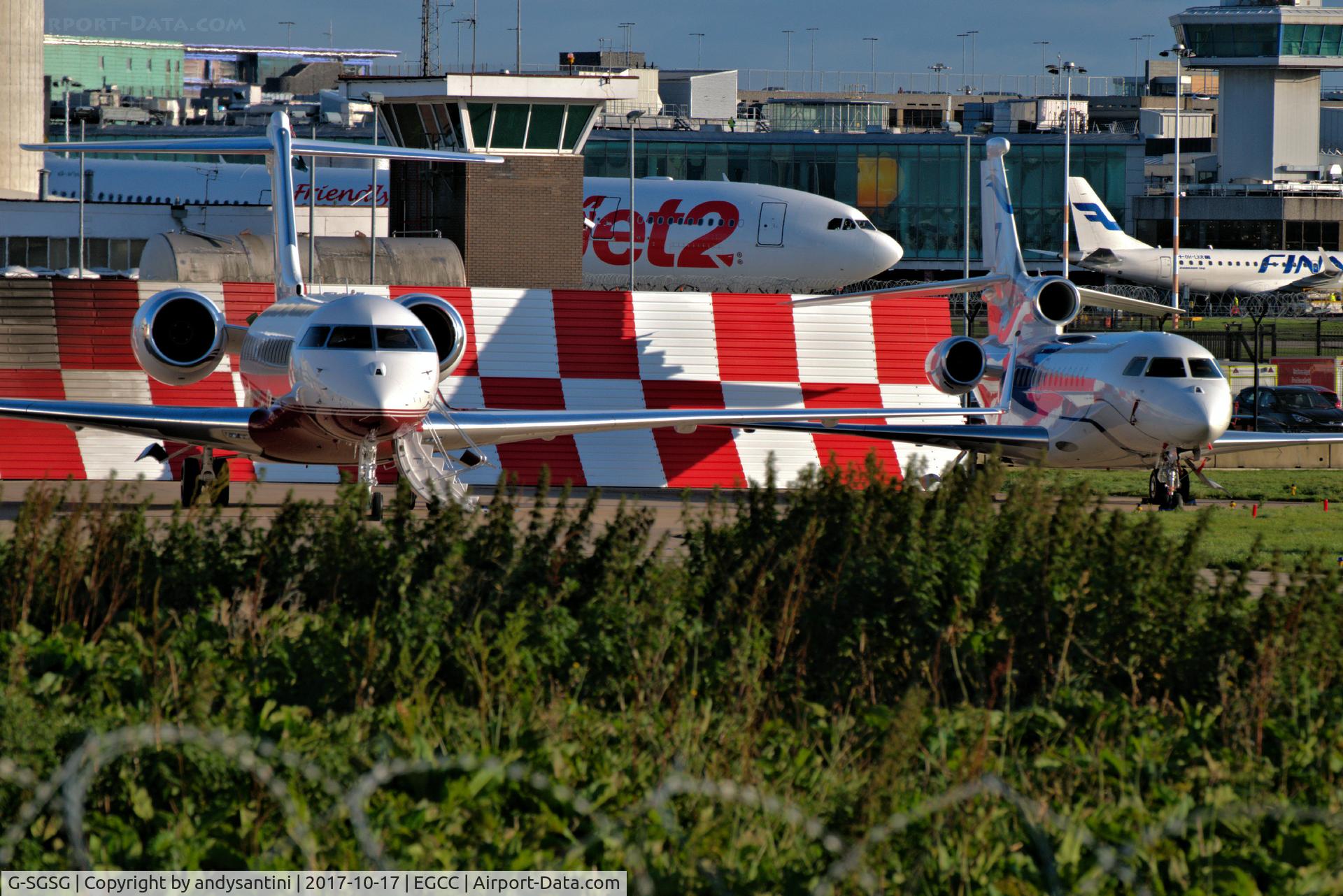 G-SGSG, 2016 Bombardier BD-700-1A11 Global 5000 C/N 9780, parked up o the FBO ramp G-SGSG is on the left of this shot/photo on the right is an DF7X.