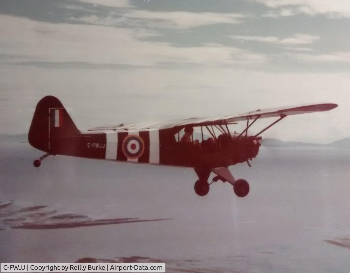 C-FWJJ, 1945 Piper J3C-65 Cub Cub C/N 13711, C-FWJJ flying over Straits of Juan de Fuca 1981