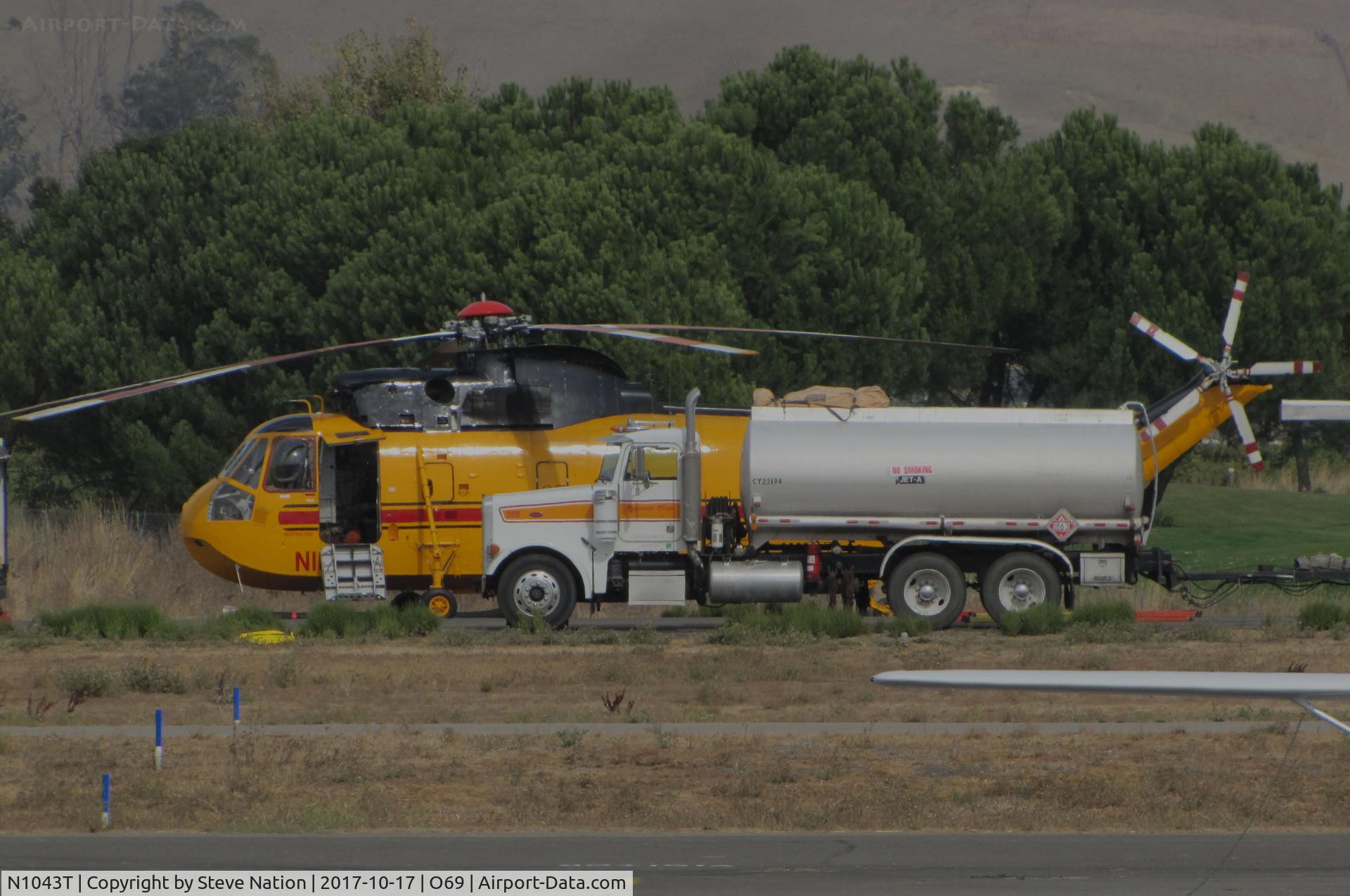 N1043T, 1982 Sikorsky S-61A (CH-3A) C/N 61-083, Croman Corp (White City, OR) 1982 Sikorsky S-61A behind fuel truck at the Petaluma Municipal Airport, CA temporary home base used by fleet of CALFIRE contracted helicopters to make water drops on the devastating October 2017 Northern California wildfires