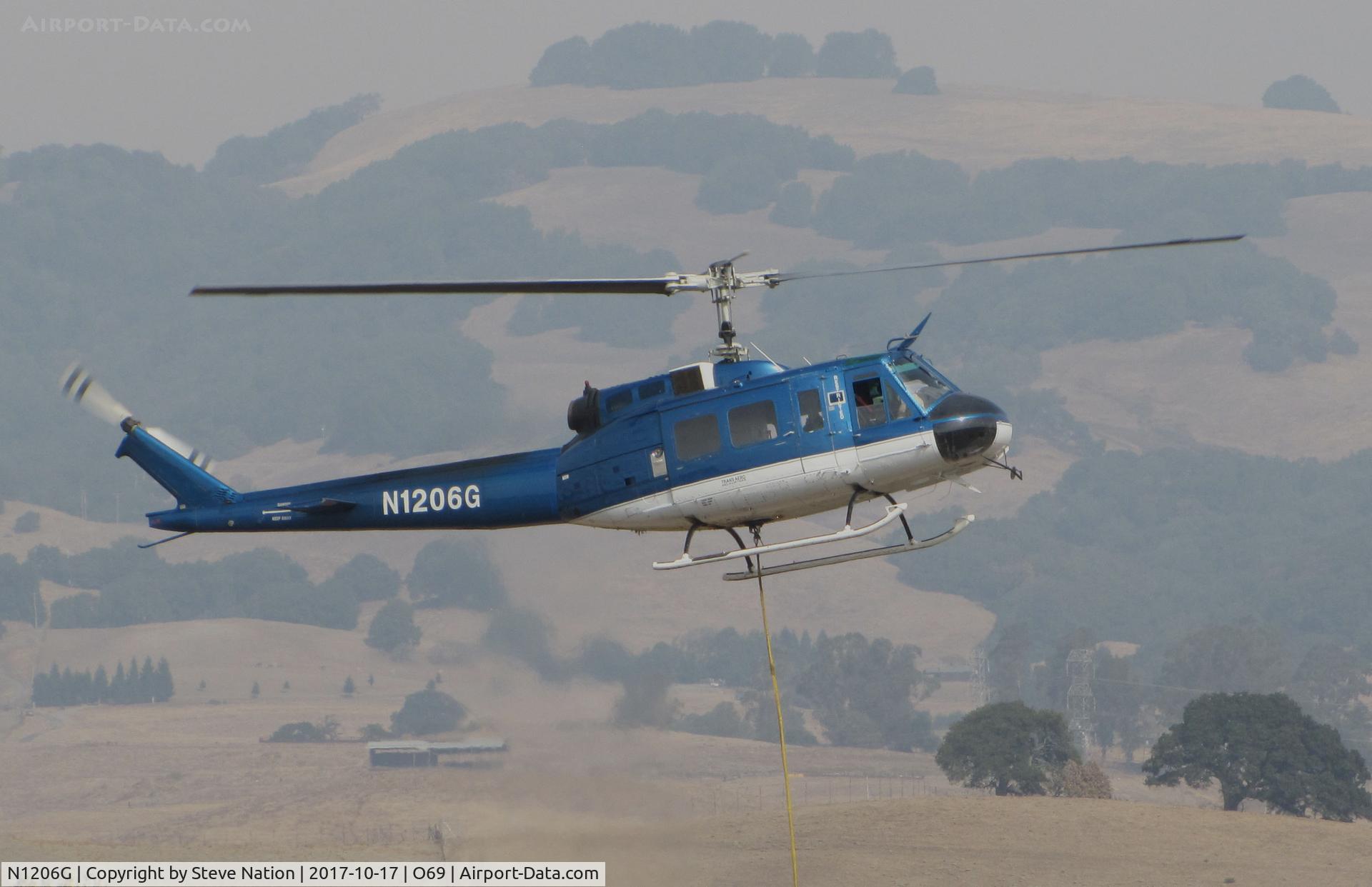 N1206G, 1966 Bell UH-1H Iroquois C/N 5269 (66-0786), Trans Aero (Cheyenne, WY) 1966 Bell UH-1H hovering at Petaluma Municipal Airport, CA temporary home base after making water drops on the devastating October 2017 Northern California wildfires