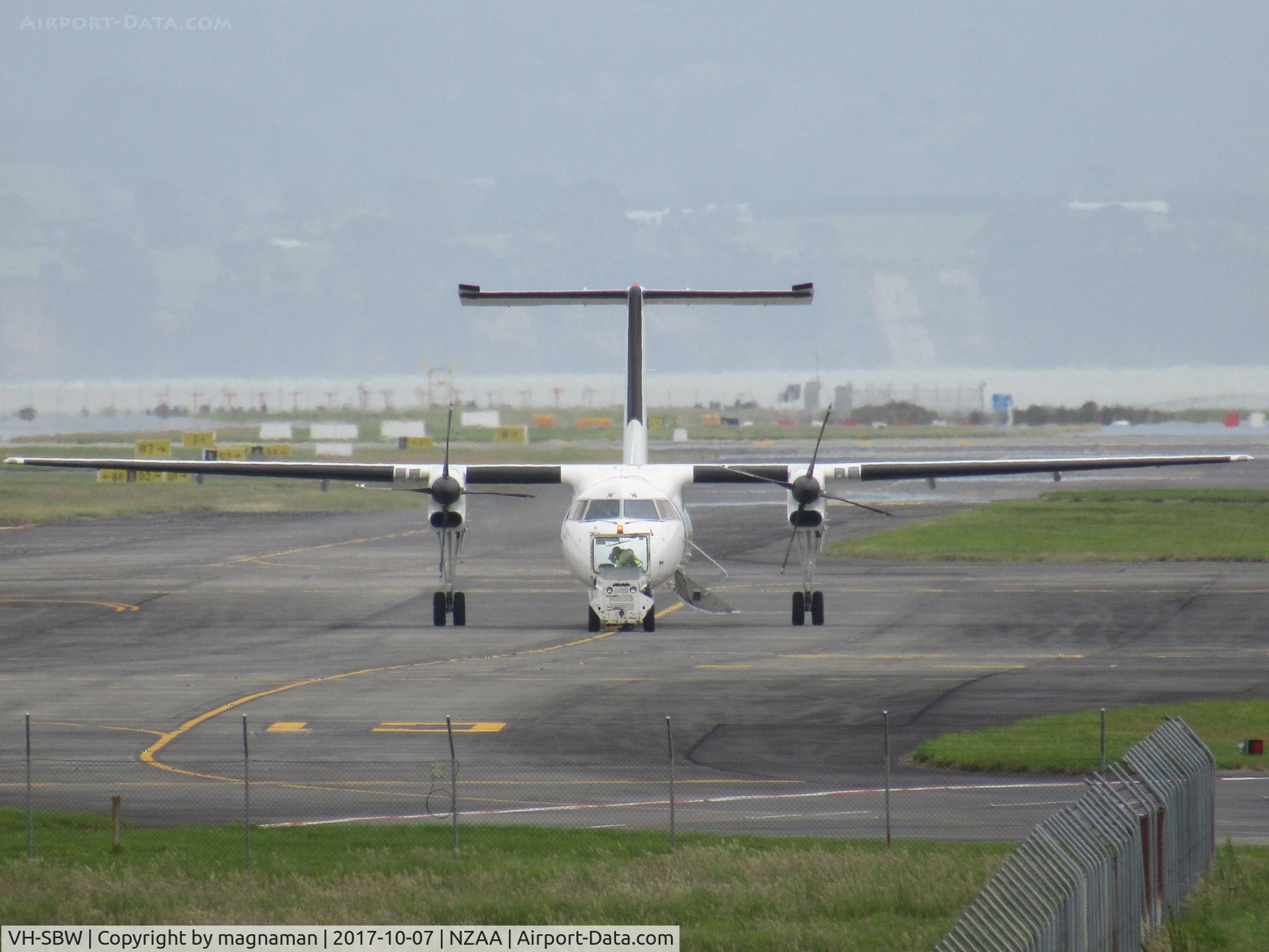 VH-SBW, 2004 De Havilland Canada DHC-8-315Q Dash 8 C/N 599, having a helping hand down taxyway