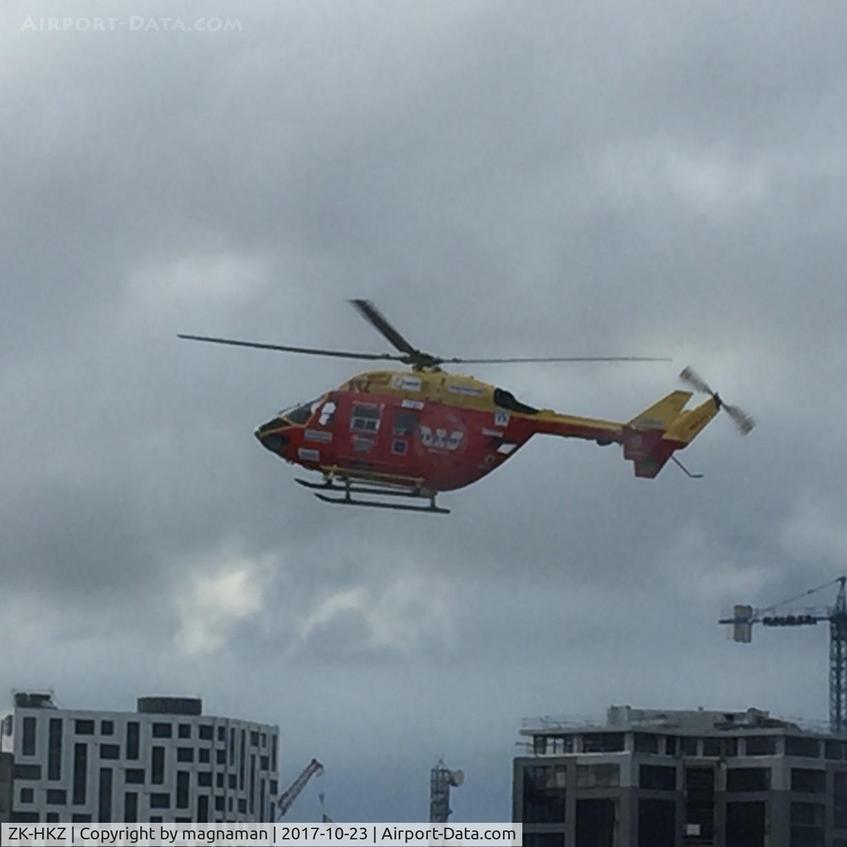 ZK-HKZ, MBB-Kawasaki BK-117B-2 C/N 1089, landing on helipad outside hospital window - Central Auckland