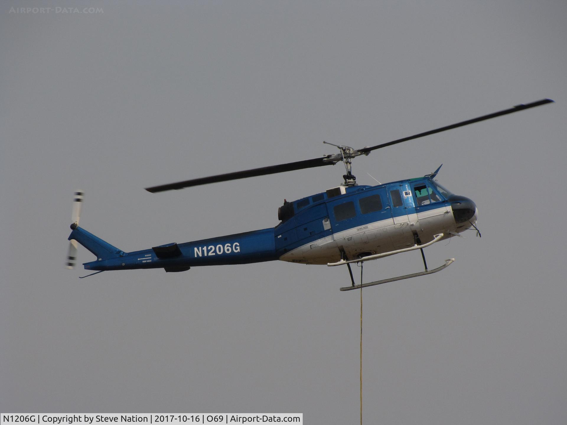 N1206G, 1966 Bell UH-1H Iroquois C/N 5269 (66-0786), Trans Aero (Cheyenne, WY) 1966 UH-1H water dropping helicopter hovers @ Petaluma Municipal Airport, CA temporary home base in support of efforts to control devastating Oct 2017 Northern California wildfires