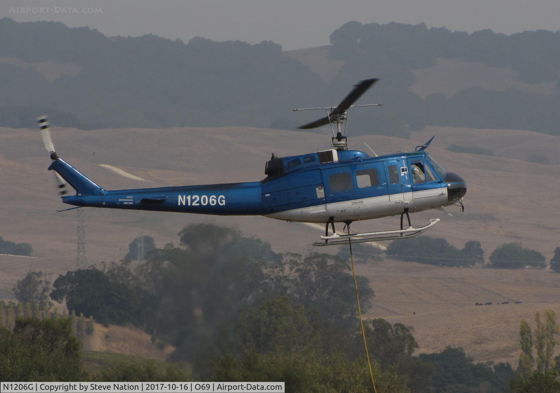 N1206G, 1966 Bell UH-1H Iroquois C/N 5269 (66-0786), Trans Aero (Cheyenne, WY) 1966 UH-1H water dropping helicopter hovers @ Petaluma Municipal Airport, CA temporary home base in support of efforts to control devastating Oct 2017 Northern California wildfires