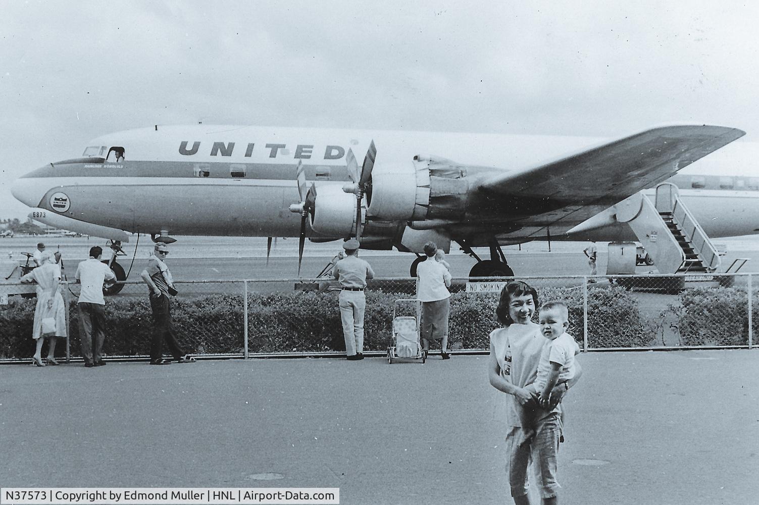 N37573, 1956 Douglas DC-6B C/N 44897, This was taken around 1960 in Hawaii. My mother is holding me in the foreground.