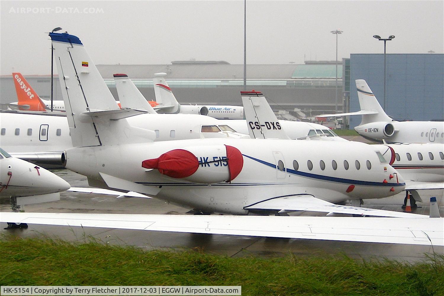 HK-5154, 2002 Israel Aircraft Industries Gulfstream 200 C/N 063, A Colombian registered bizjet brightening the crowded Harrods ramp on a cold grey day at  London-Luton Airport