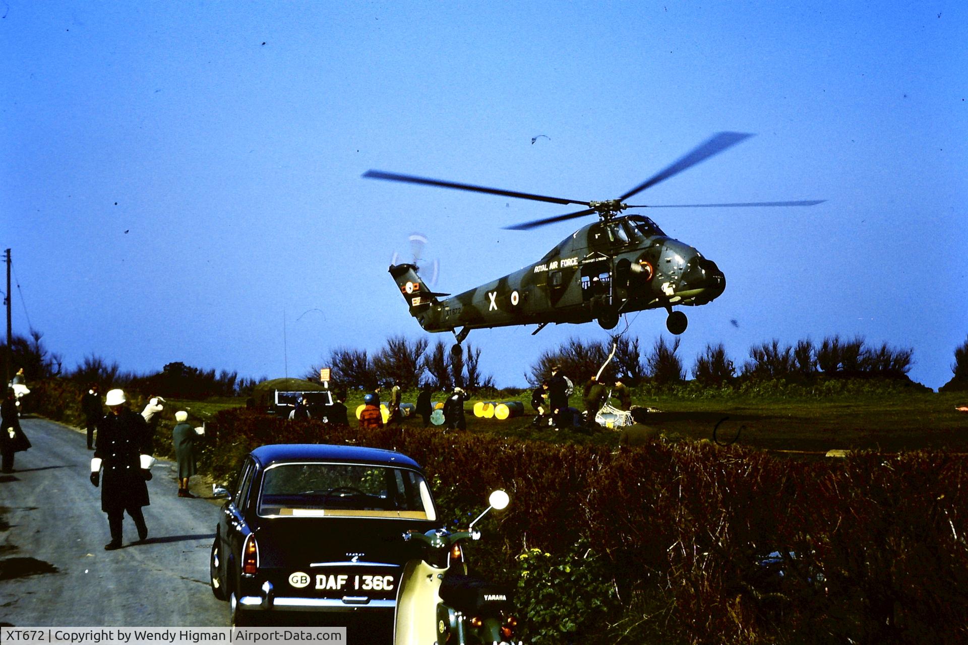 XT672, 1966 Westland Wessex HC.2 C/N WA540, Loading cargo nets with barrels of detergent to drop on the rocks during the Torrey Canyon disaster. Photo taken by my mother at Trevone, North Cornwall on 15th April 1967.