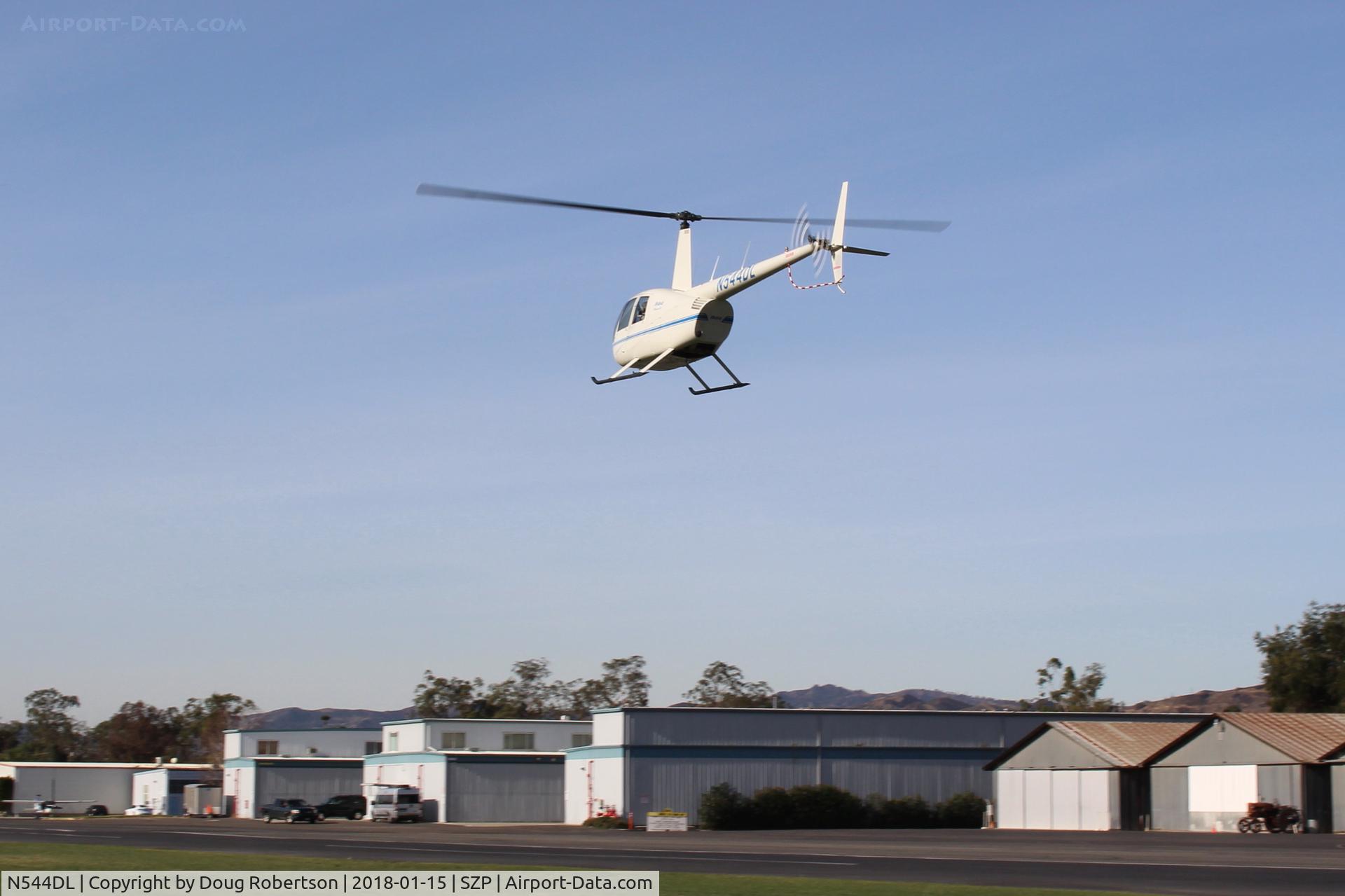 N544DL, 2005 Robinson R44 Raven II C/N 10783, 2005 Robinson R44 RAVEN II, Lycoming IO-540-AE1A5 6 cylinder 260 Hp derated to 225 Hp for takeoff, 205 Hp continuous, approaching to land near its hangar