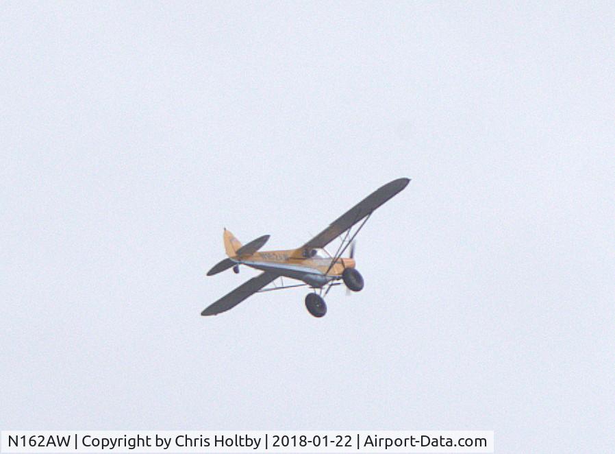 N162AW, 1981 Piper PA-18-150 Super Cub C/N 18-8109082, Slow flying over Potters Bar at distance and in gloomy conditions