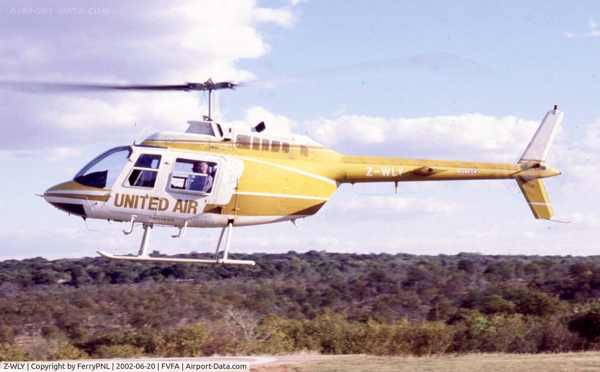 Z-WLY, Bell 206B JetRanger II C/N 1881, Scan of United Air B206 lifting-off from Victoria Falls Helipad.