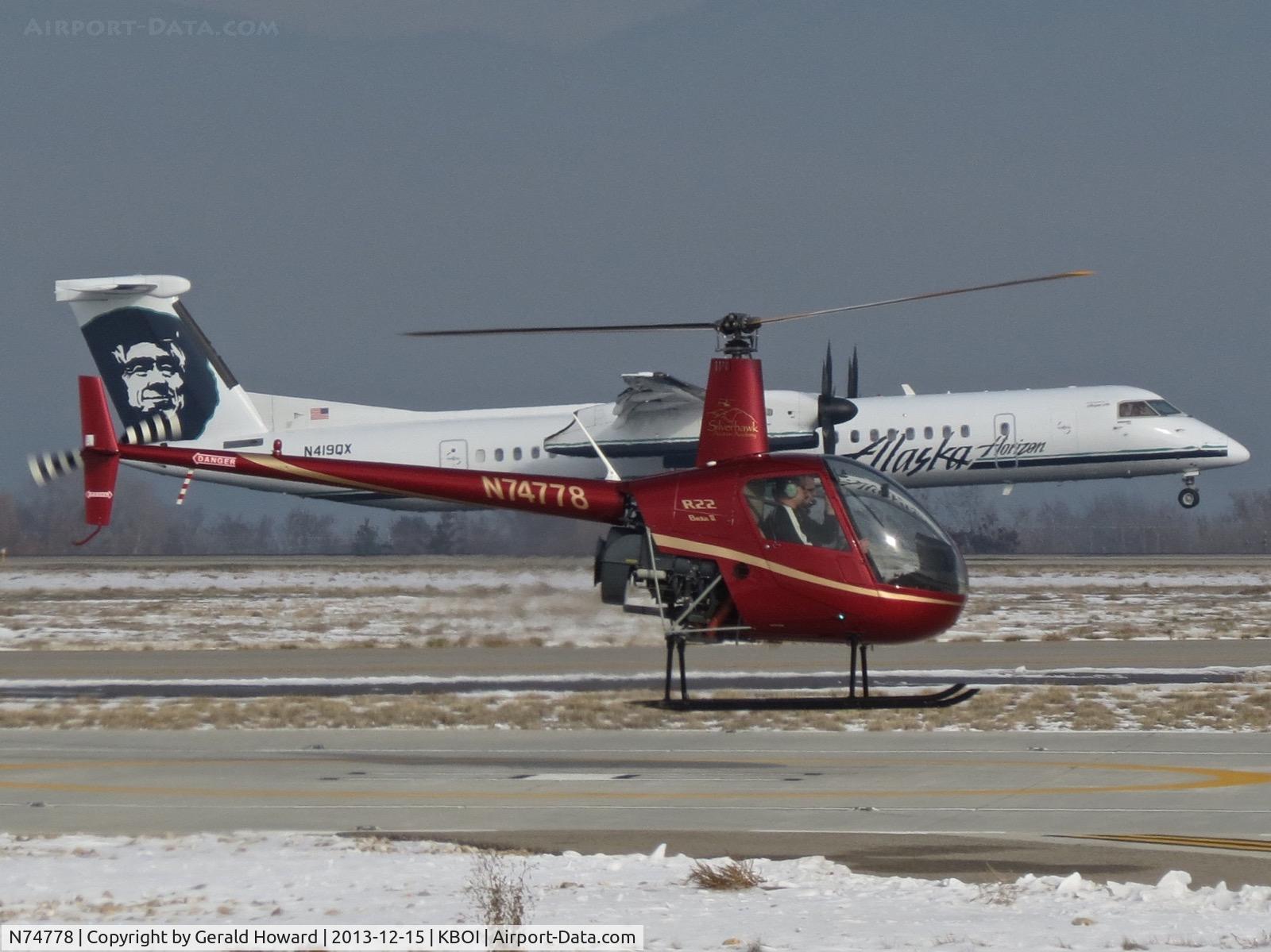 N74778, 2005 Robinson R22 Beta C/N 3968, Departing helipad while Dash 8 lands on RWY 10R.