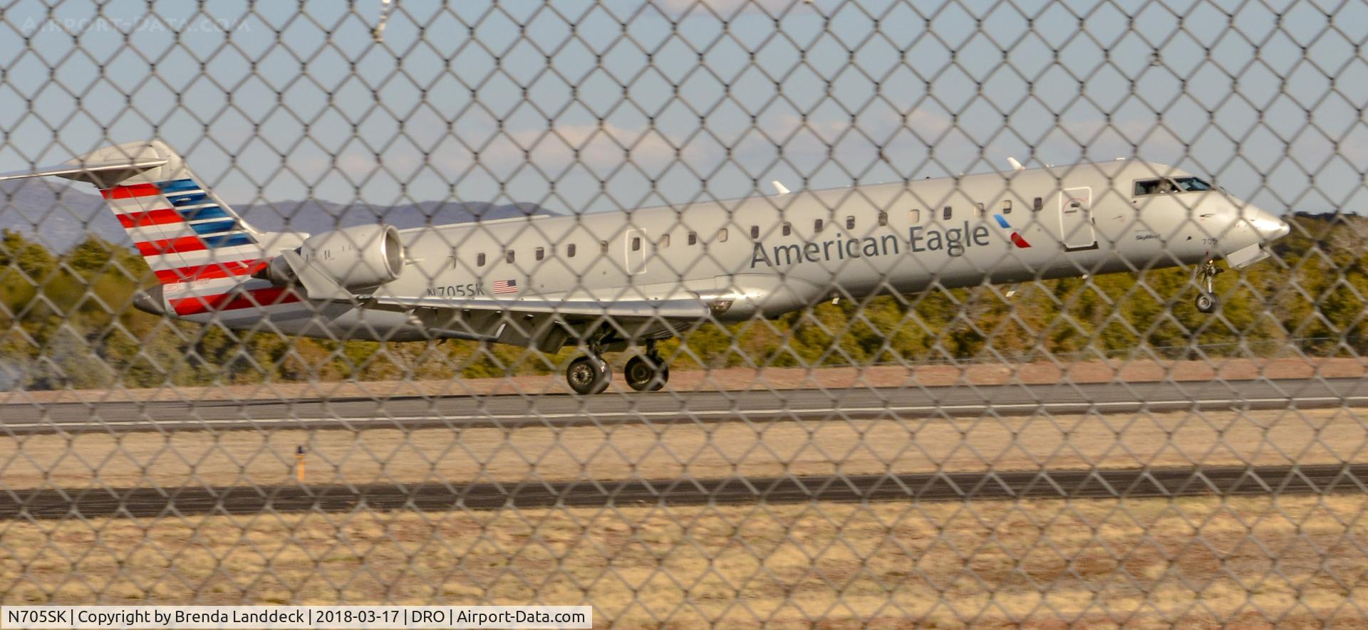 N705SK, 2004 Bombardier CRJ-701 (CL-600-2C10) Regional Jet C/N 10145, Sorry about that chain link fence but a nice landing in Durango, Colorado.