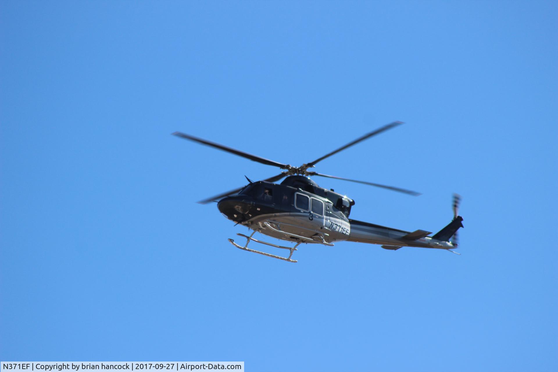 N371EF, 2007 Bell 412EP C/N 36448, flying over Goldfield