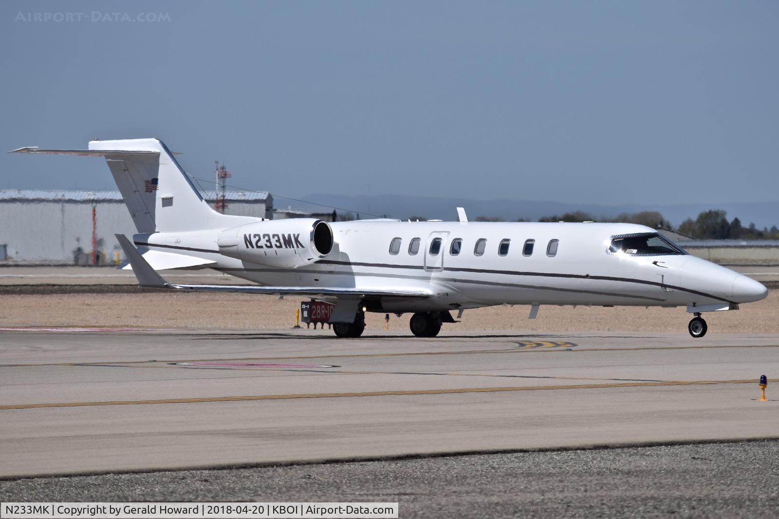 N233MK, 1999 Learjet 45 C/N 052, Taxiing to parking on the north GA ramp.