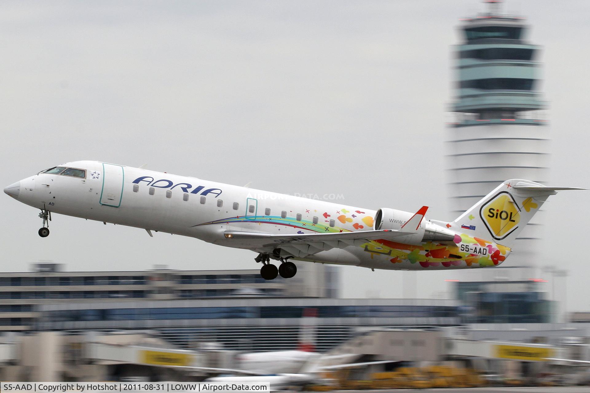 S5-AAD, 1997 Canadair CRJ-200LR (CL-600-2B19) C/N 7166, Departing in front of the ATC tower