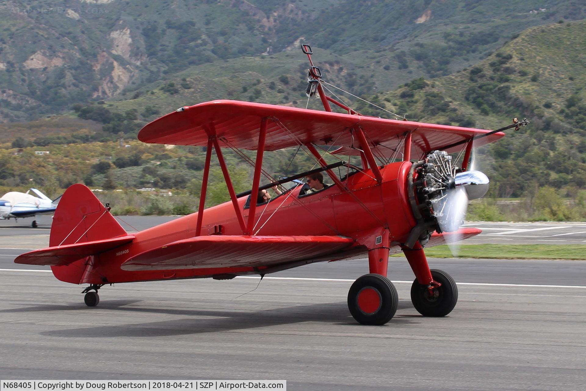 N68405, 1943 Boeing A75N1(PT17) C/N 75-7759, 1943 Boeing Stearman A75N1 (PT-17), P&W R-985 Wasp Jr. 450 Hp upgrade, taxi off Rwy 22. Wing rider has climbed down into rear cockpit.