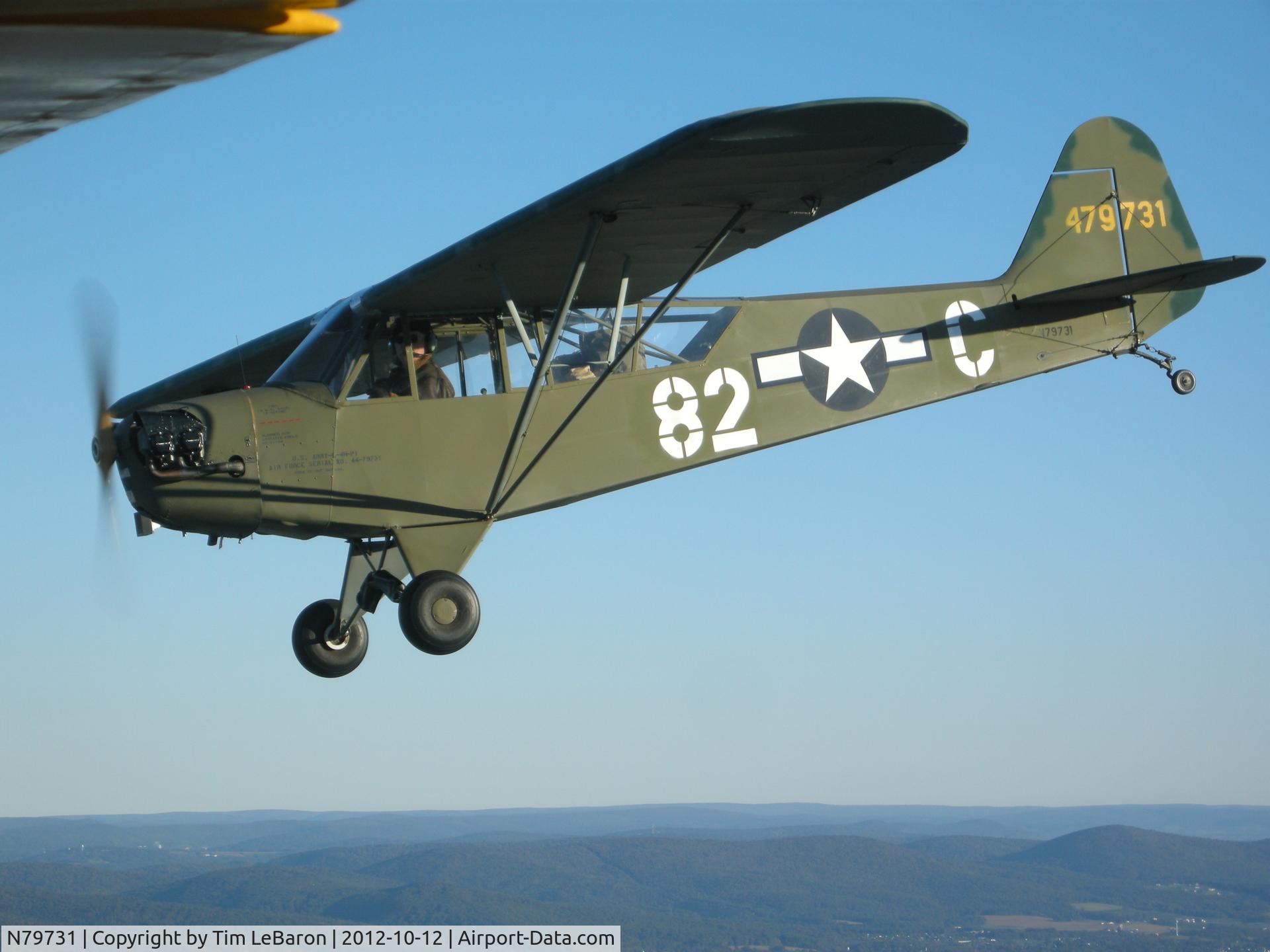 N79731, 1944 Piper L-4H Grasshopper (J3C-65D) C/N 12027, This is 44-79731 as she appeared in 1945 after a rebuild from being wrecked in February in Laffeld, Germany with the 407th FA Bn. She is flown regularly to air shows and displays and lives in central Maryland USA. Owner is Paul Smith
