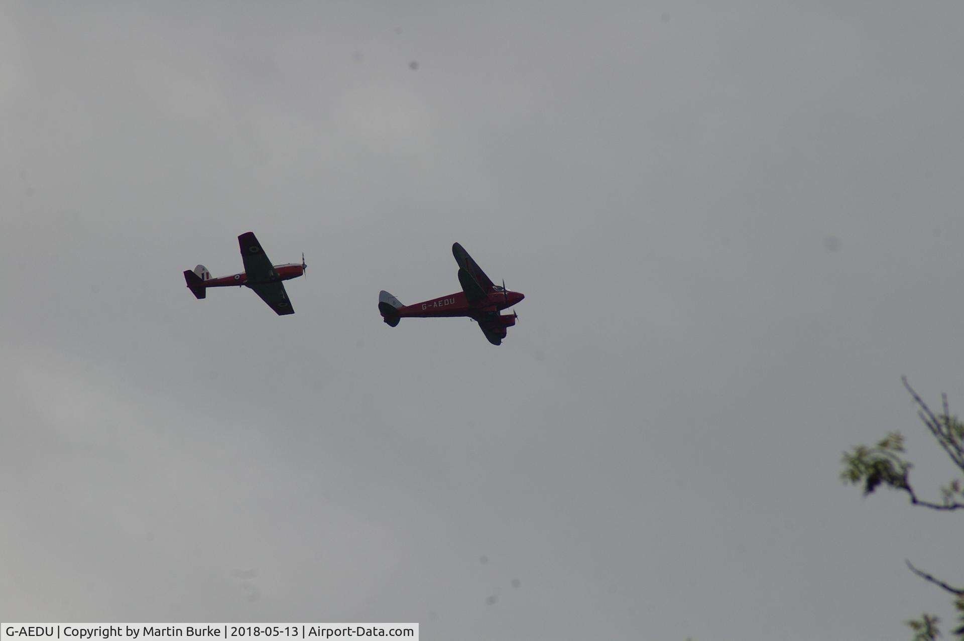 G-AEDU, 1937 De Havilland DH-90A Dragonfly C/N 7526, This pair flew over Happy Valley, Coulsdon, Surrey, today. I took several pictures. I cannot identify the mono-plane but the De Havilland's G registration is easily seen.