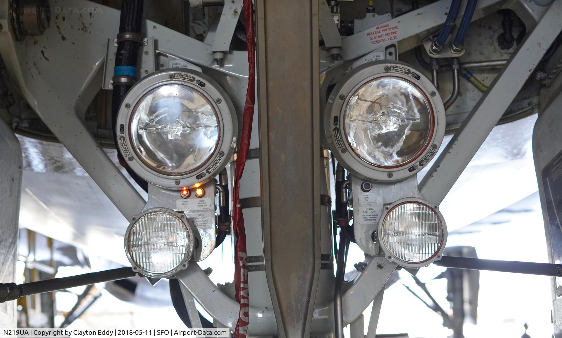 N219UA, 2001 Boeing 777-222 C/N 30551, Nose gear landing light. SFO. 2018.