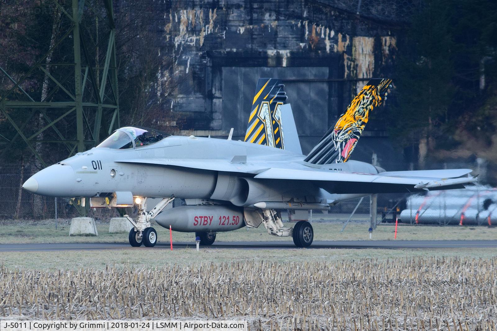 J-5011, McDonnell Douglas F/A-18C Hornet C/N 1351, Fightersquadron 11 special decoration leaving the mountain cavern area - note the Live ammunition due WEF-CAP