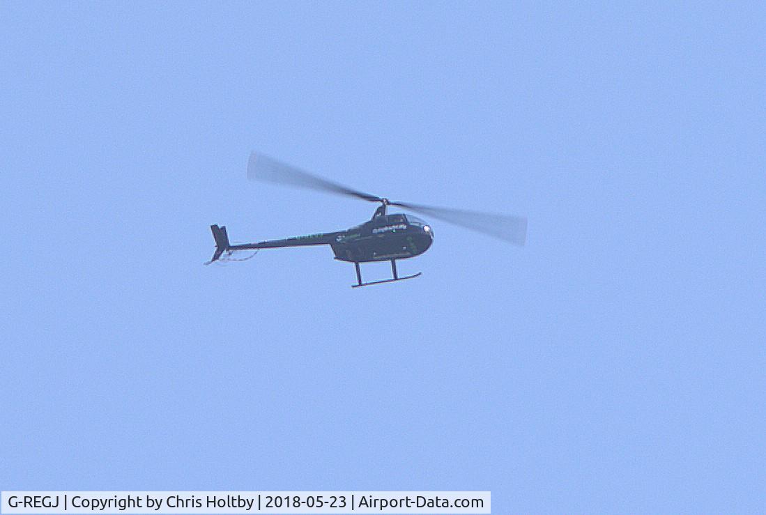 G-REGJ, 2003 Robinson R44 Raven II C/N 10235, Bit distantly over Potters Bar from its base at Denham