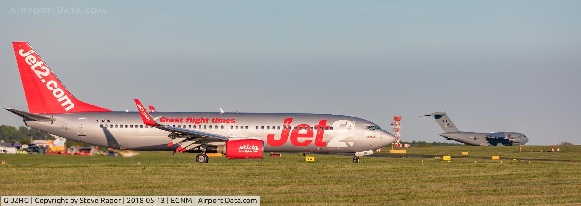 G-JZHG, 2000 Boeing 737-85P C/N 28388, On the ground at LBA with 177703 RCAF C-17 in the distance.