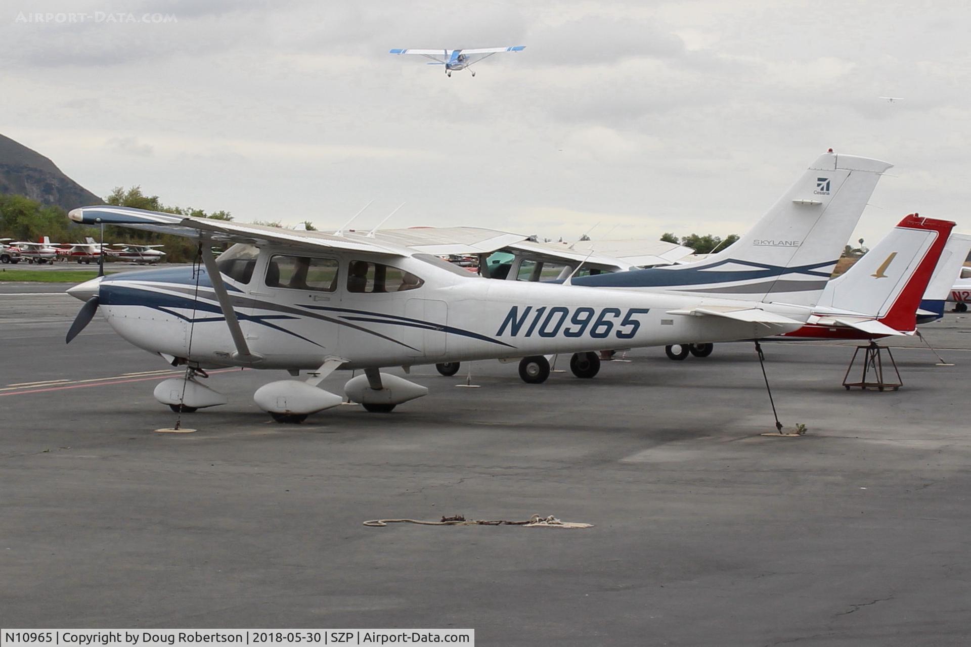 N10965, 2007 Cessna 182T Skylane C/N 18281976, 2007 Cessna 182T SKYLANE, Lycoming IO-540-AB1A5 230 Hp on transient Ramp, with N117CP on takeoff climb Rwy 22