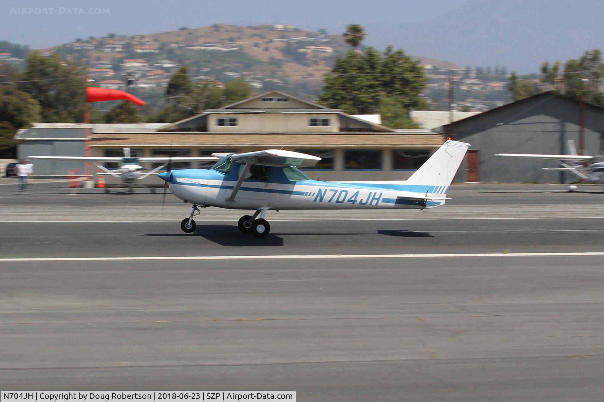 N704JH, 1976 Cessna 150M C/N 15078644, 1976 Cessna 150, Continental O-200 100 Hp, landing roll Rwy 22. Note new added third windsock and location.