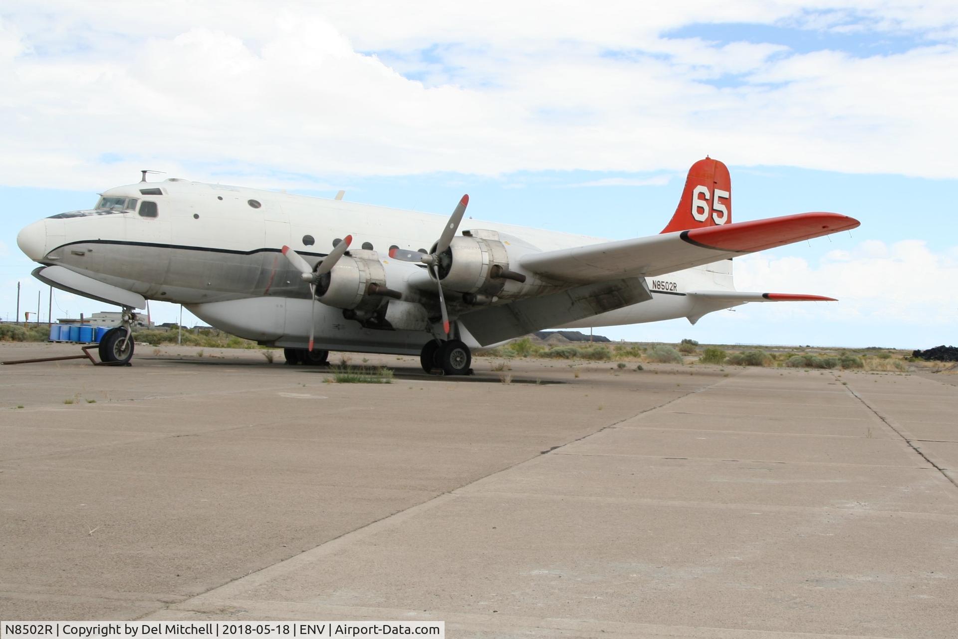 N8502R, 1981 Douglas C-54E Skymaster (DC-4) C/N 27367, Douglas C-54T Skymaster.  Sitting at Wendover Airport, UT on 18 May 2018, the airplane is becoming an eyesore due to neglect and the environment.  Oil seeps from the engines onto the tarmac, starboard elevator has torn canvas.