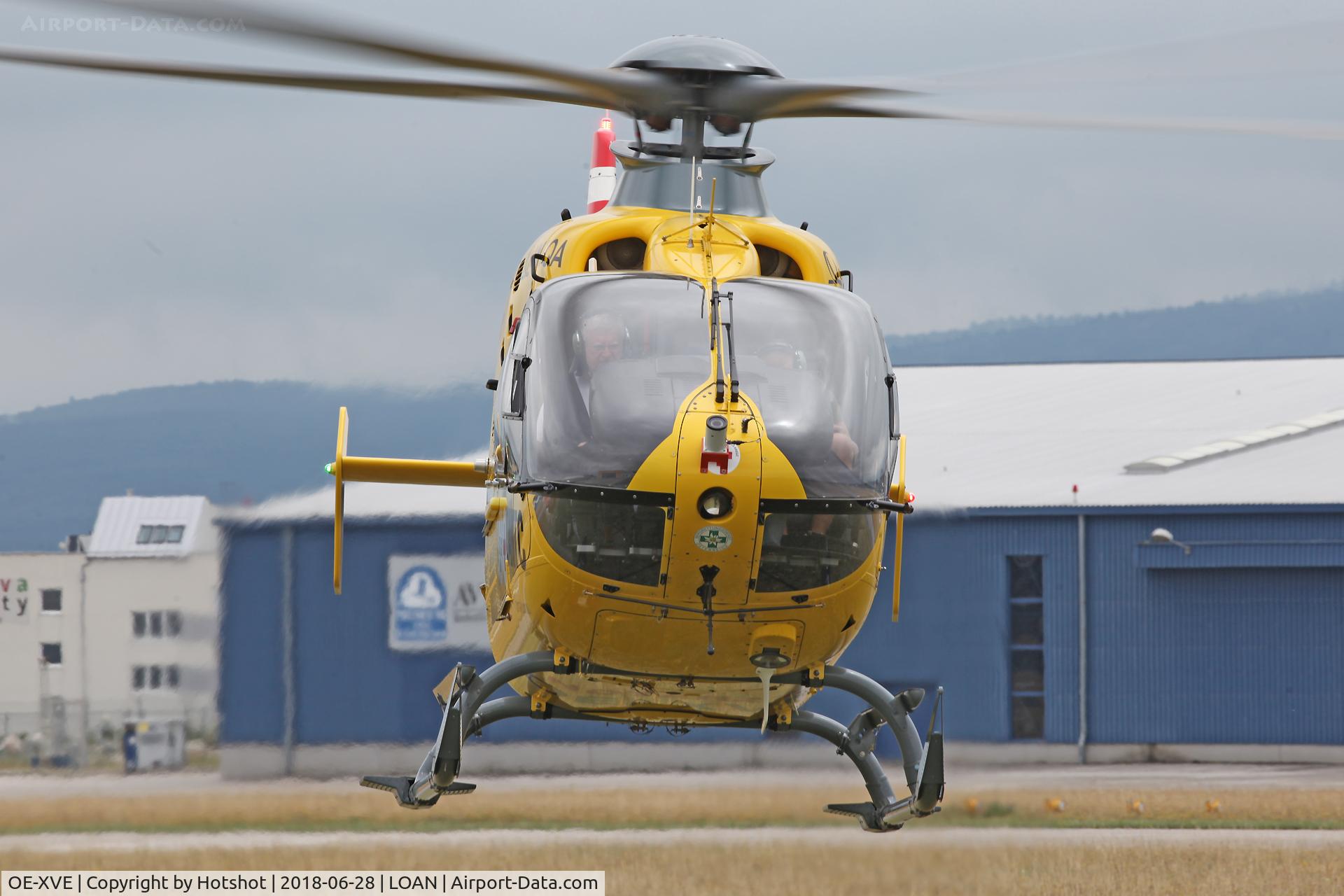 OE-XVE, 2004 Eurocopter EC-135T-2 C/N 0374, Hovering during a test flight with the beacon flashing.