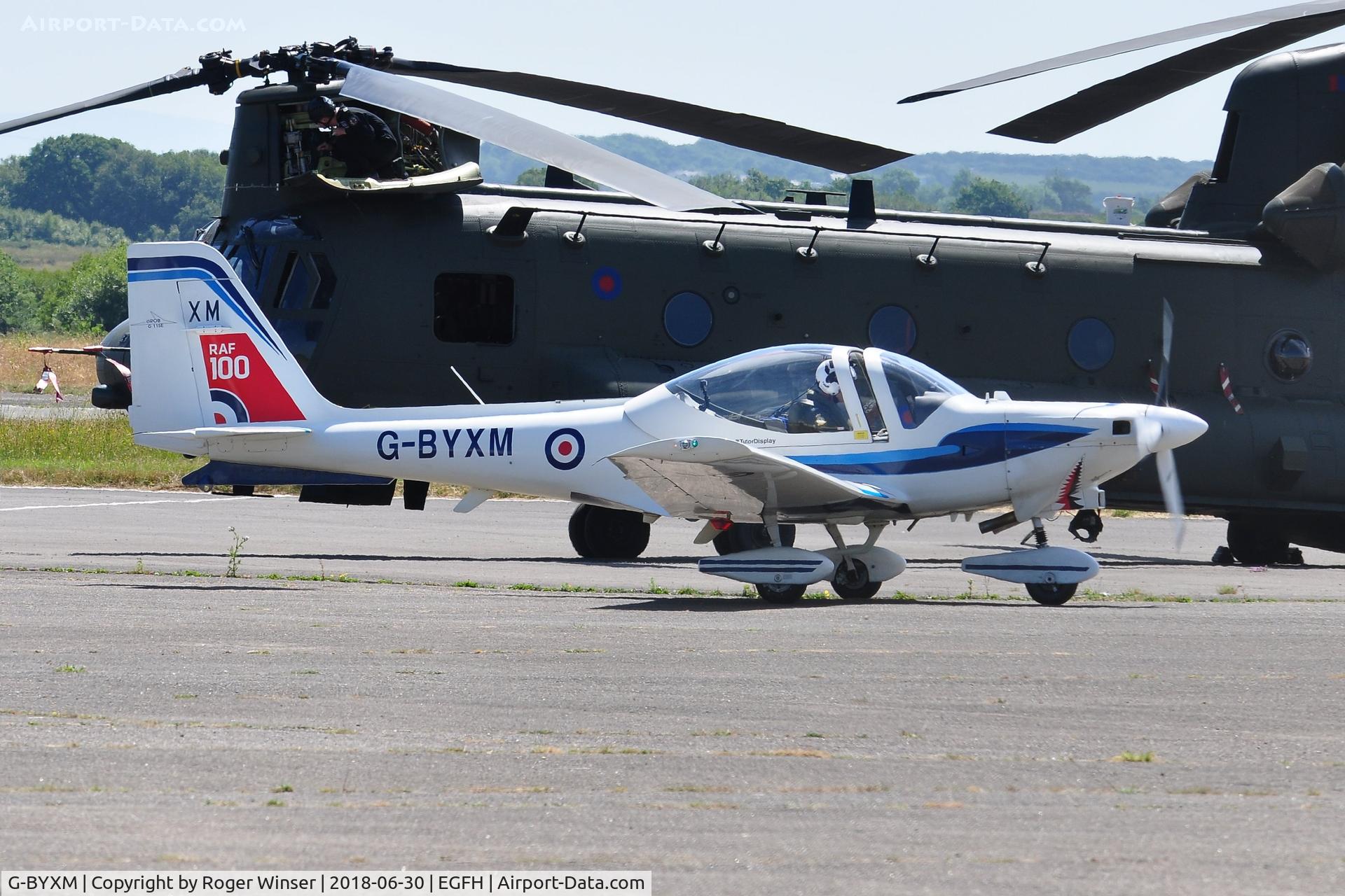 G-BYXM, 2001 Grob G-115E Tutor T1 C/N 82173/E, RAF Tutor T.1 aircraft coded XM about to depart and display on day 1 of WNAS18. RAF display Chinook HC.6A helicoter ZH891 in the background.