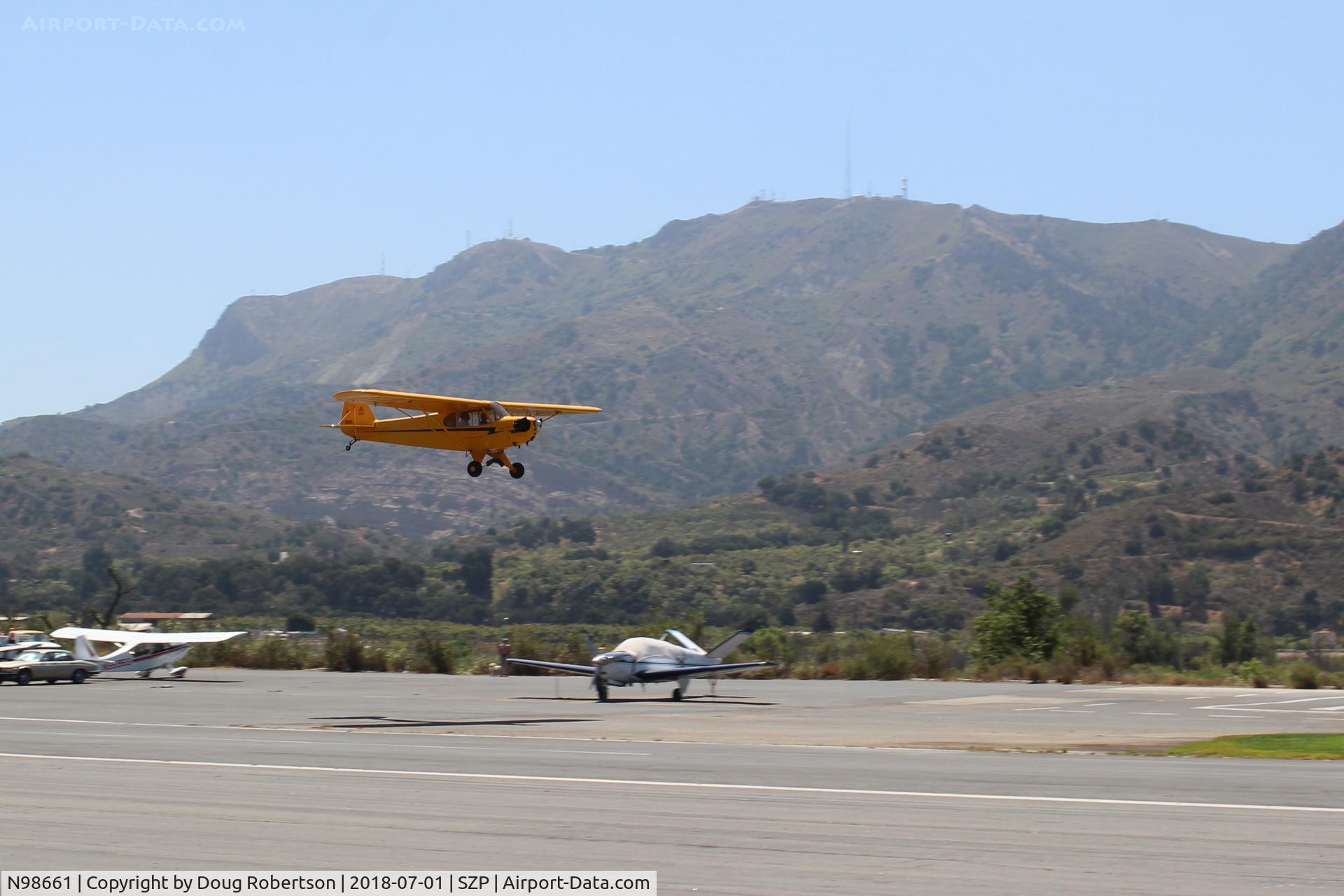 N98661, 1946 Piper J3C-65 Cub Cub C/N 18890, 1946 Piper J3C-65 CUB, Continental A&C75 75 Hp upgrade, on final for Rwy 22L grass