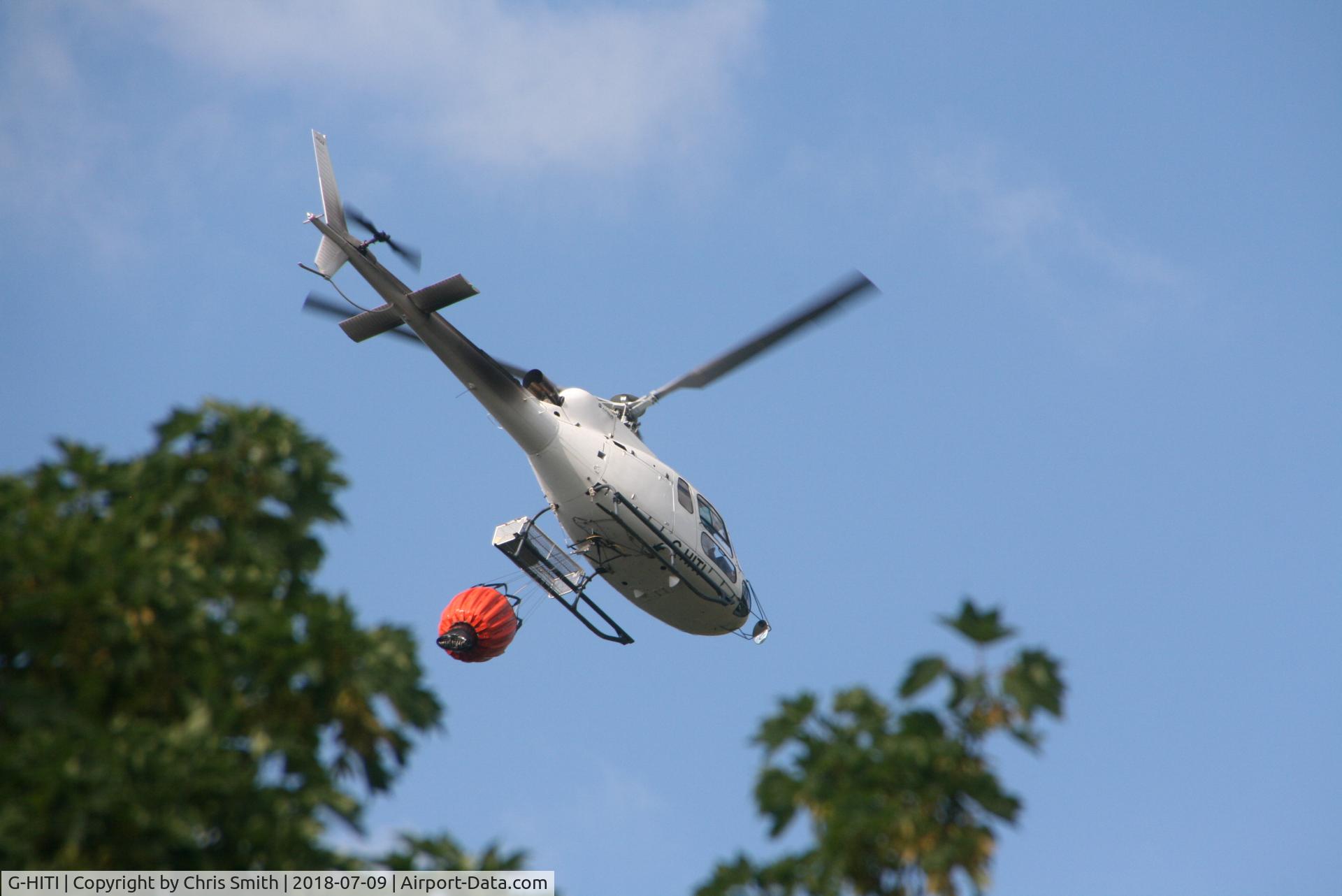 G-HITI, 2016 Airbus Helicopters AS-350B-3 Ecureuil C/N 8239, In use dropping water over the mountain at the rear of  Cwmcelyn, Gwent
