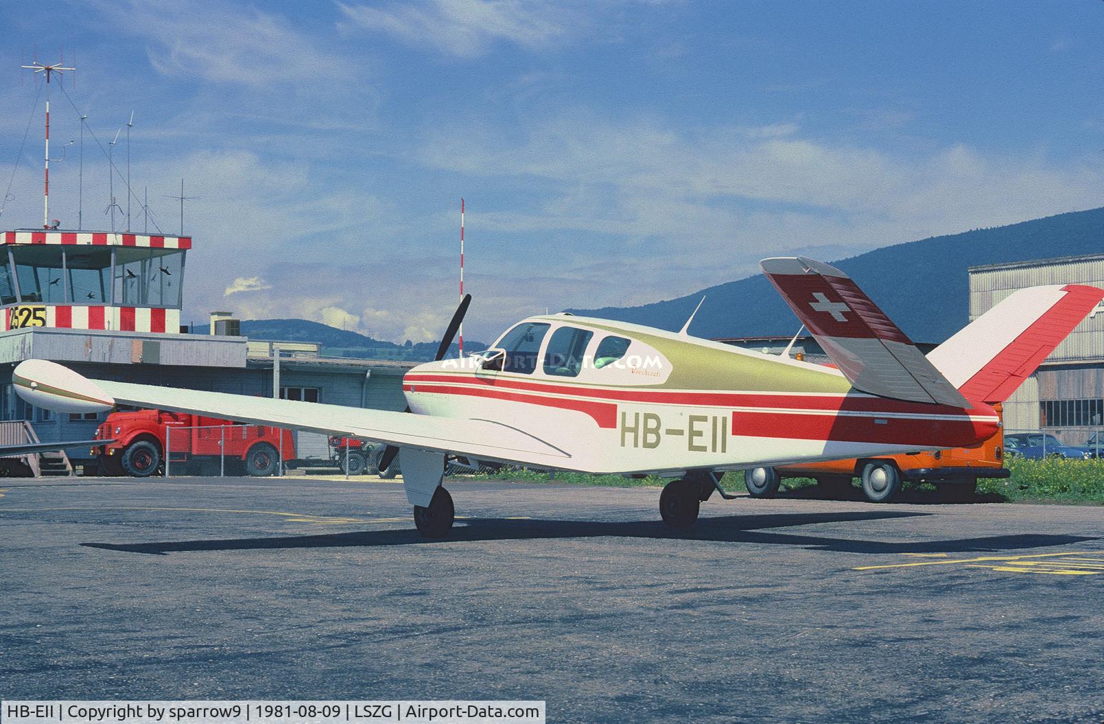 HB-EII, 1955 Beechcraft F35 Bonanza C/N D-4019, In the background the old wooden Tower at Grenchen, when all was much easier. Scanned from a slide.