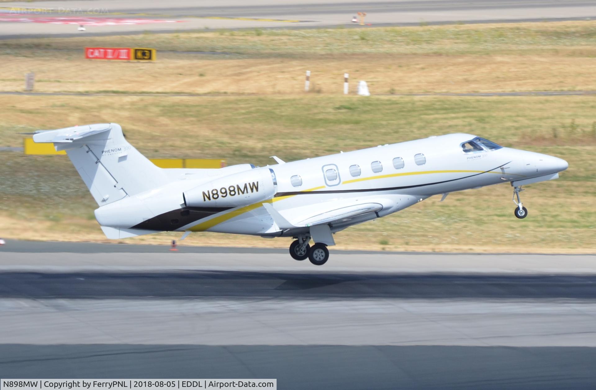 N898MW, 2011 Embraer EMB-505 Phenom 300 C/N 50500048, Phenom 300 lifting off during departure from DUS