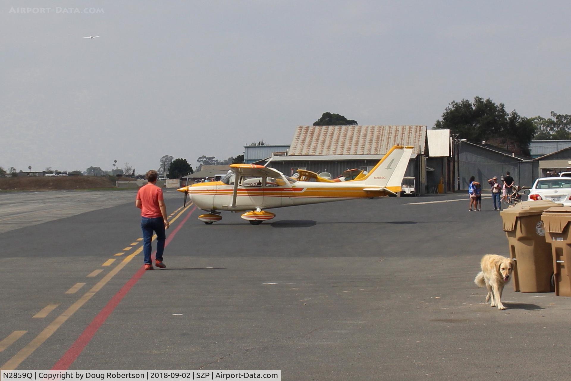 N2859Q, 1971 Cessna 172L C/N 17259859, 1971 Cessna 172L SKYHAWK, Lycoming O-320-E2D 150 Hp, on Transient Ramp, and Winnie, the Mason's airport dog on slow approach.
