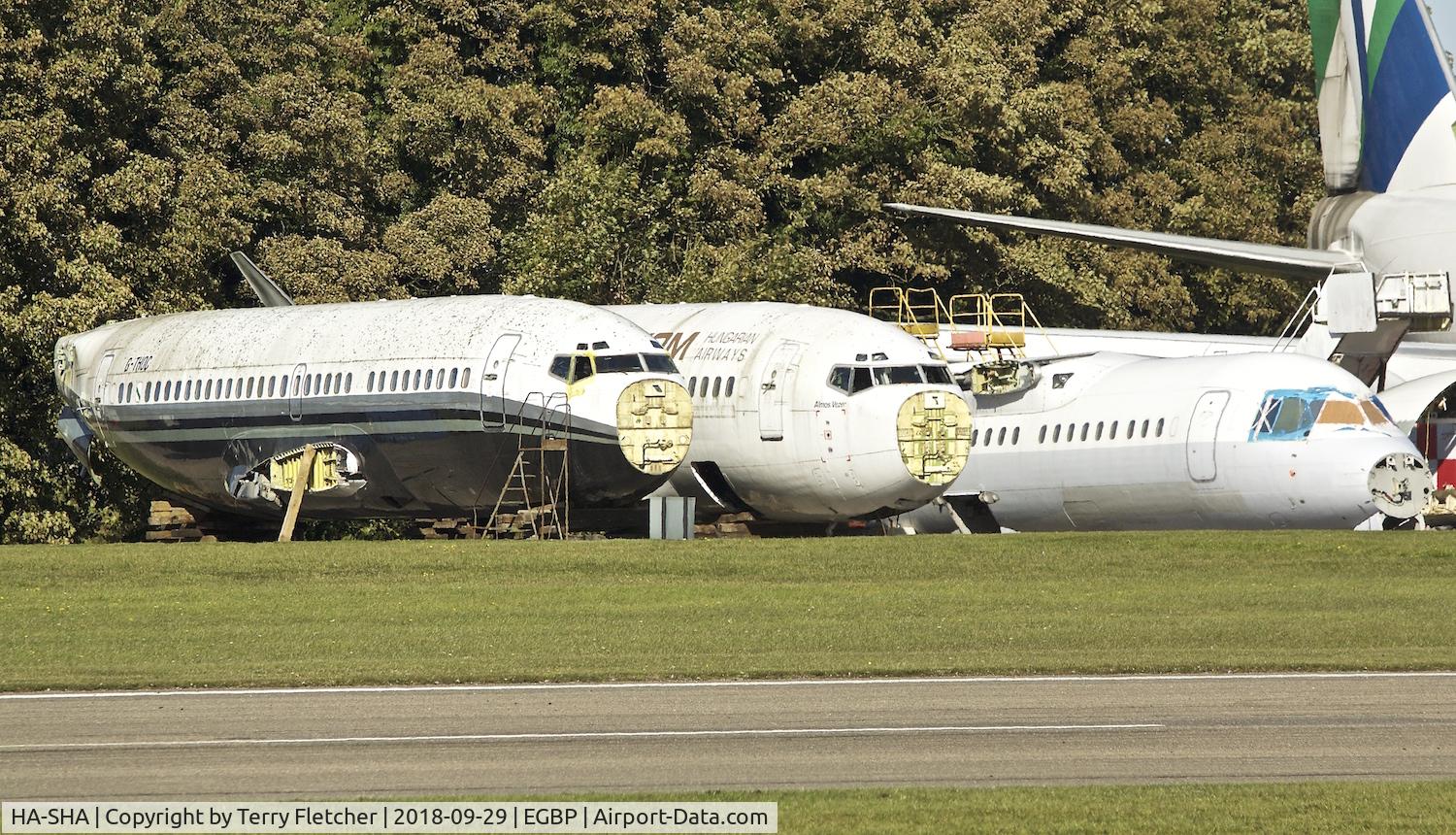 HA-SHA, 1992 Boeing 737-505 C/N 24648, With Air Salvage International for parting out at Cotswold Airport  Kemble , UK ; HA-SHA is in the centre of the three fuselages