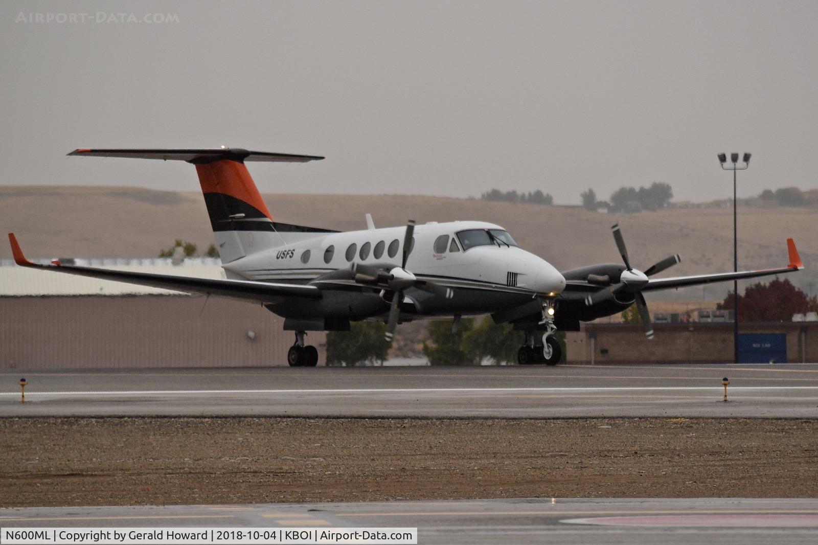 N600ML, 2001 Learjet 60 C/N 217, U. S. Forest Service aircraft crossing RWY 28R on Delta. Beechcraft B200GT, c/n: BY 87