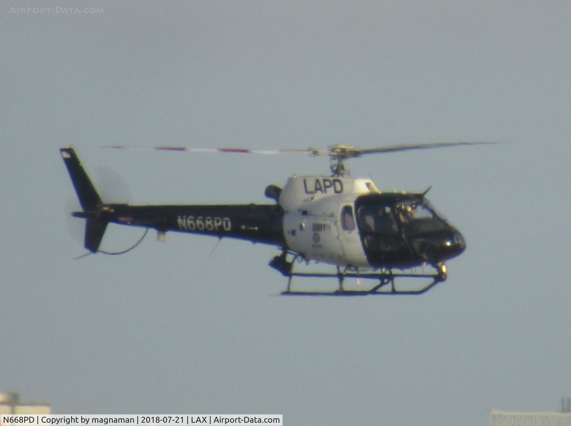N668PD, 2009 Aerospatiale AS-350B-2 Ecureuil C/N 4654, long range shot from inside terminal as this took off from near biz jet ramp.